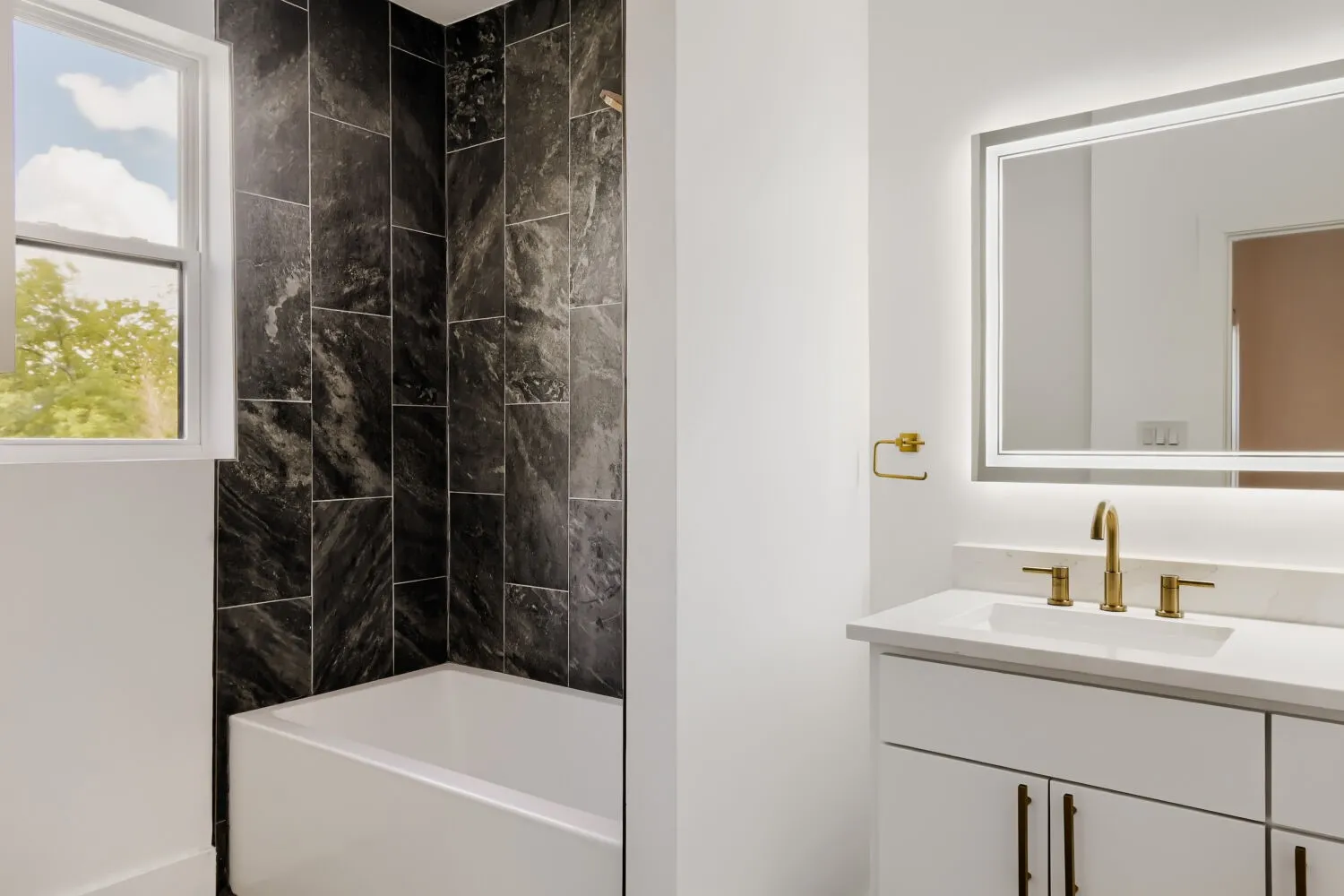 Bathroom featuring vanity and shower / bathtub combination