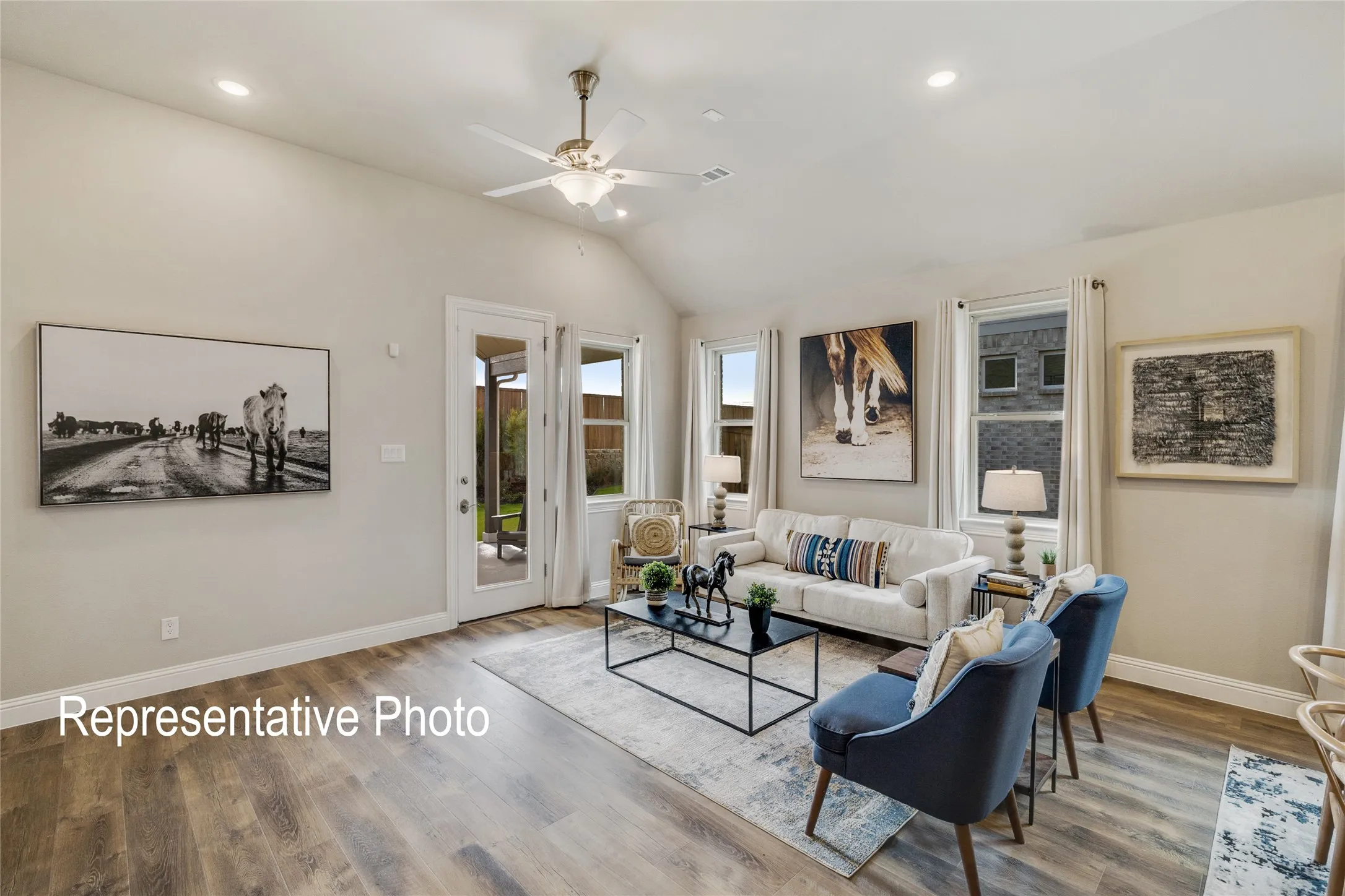 The living room features vaulted ceilings, recessed lighting, and wood-look flooring