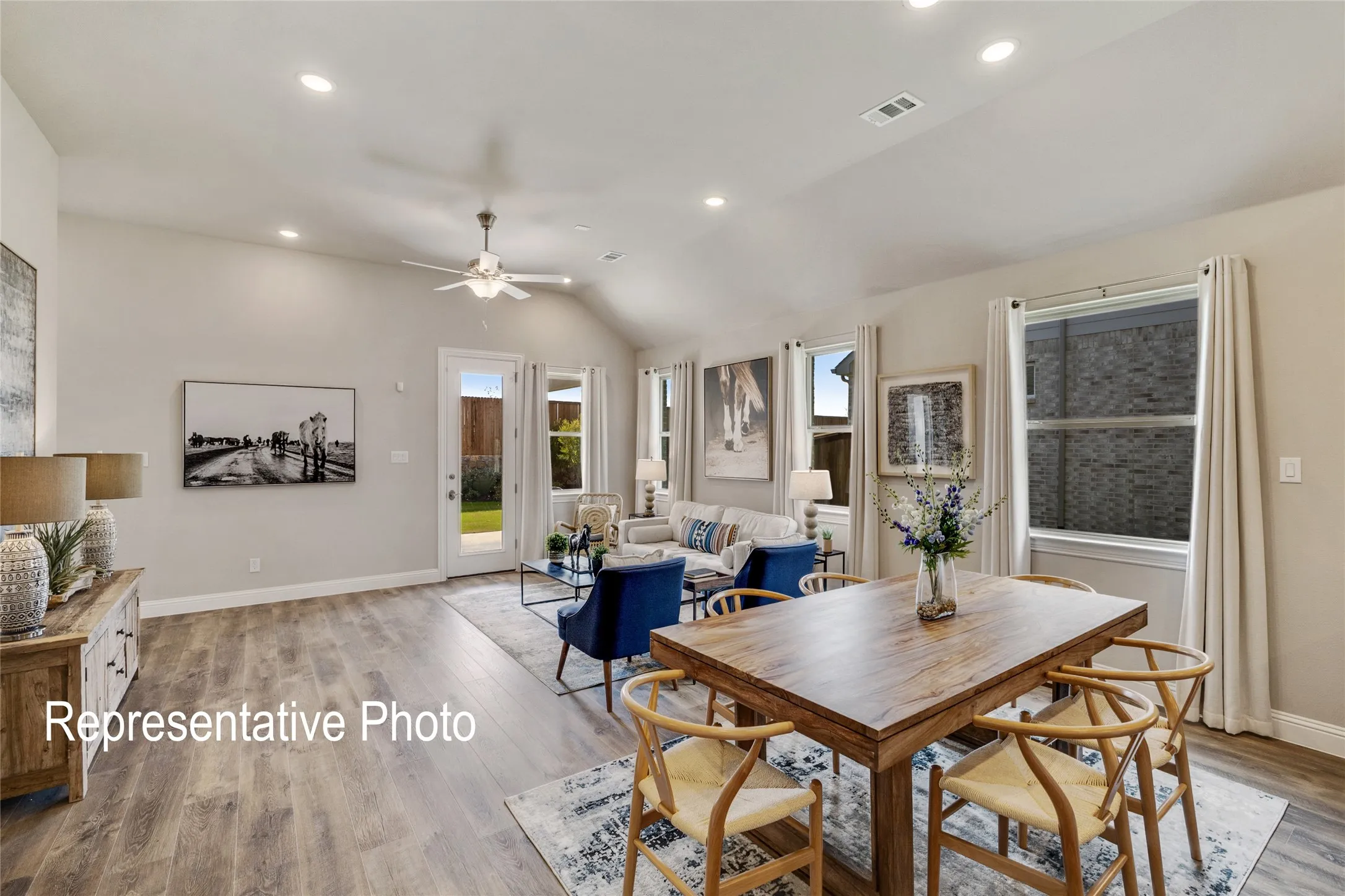 Open concept living area featuring wood-look flooring, recessed lighting, and a ceiling fan
