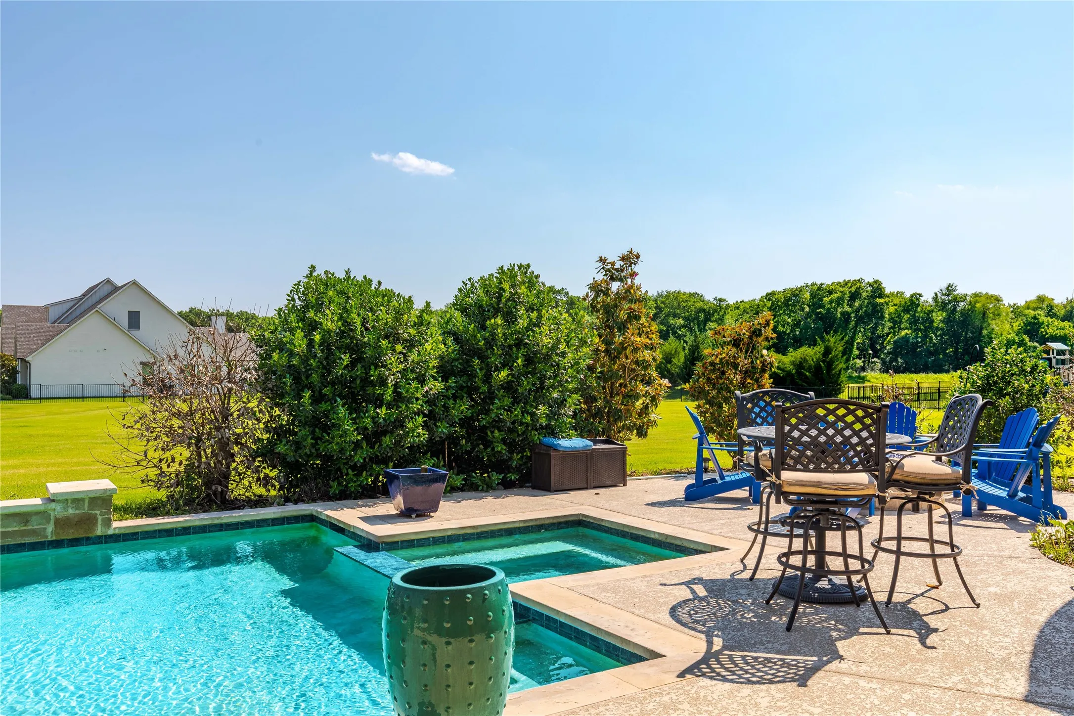 View of pool featuring a yard, a patio area, a fenced in pool, and fence