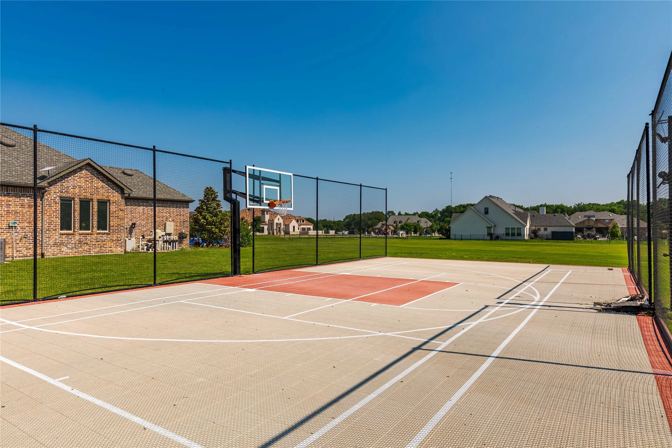 View of basketball court with a lawn and community basketball court