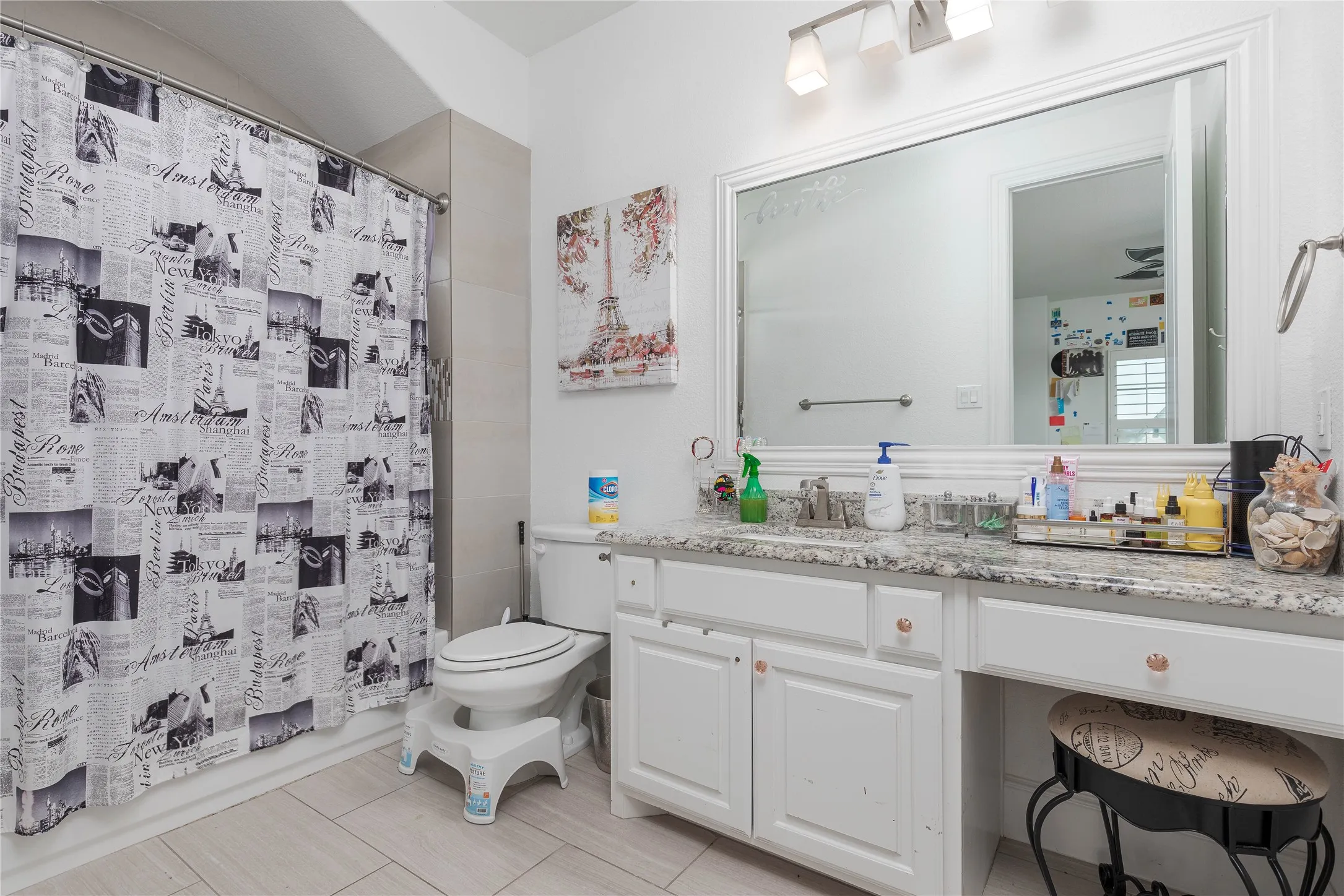 Full bath with toilet, vanity, and tile patterned floors