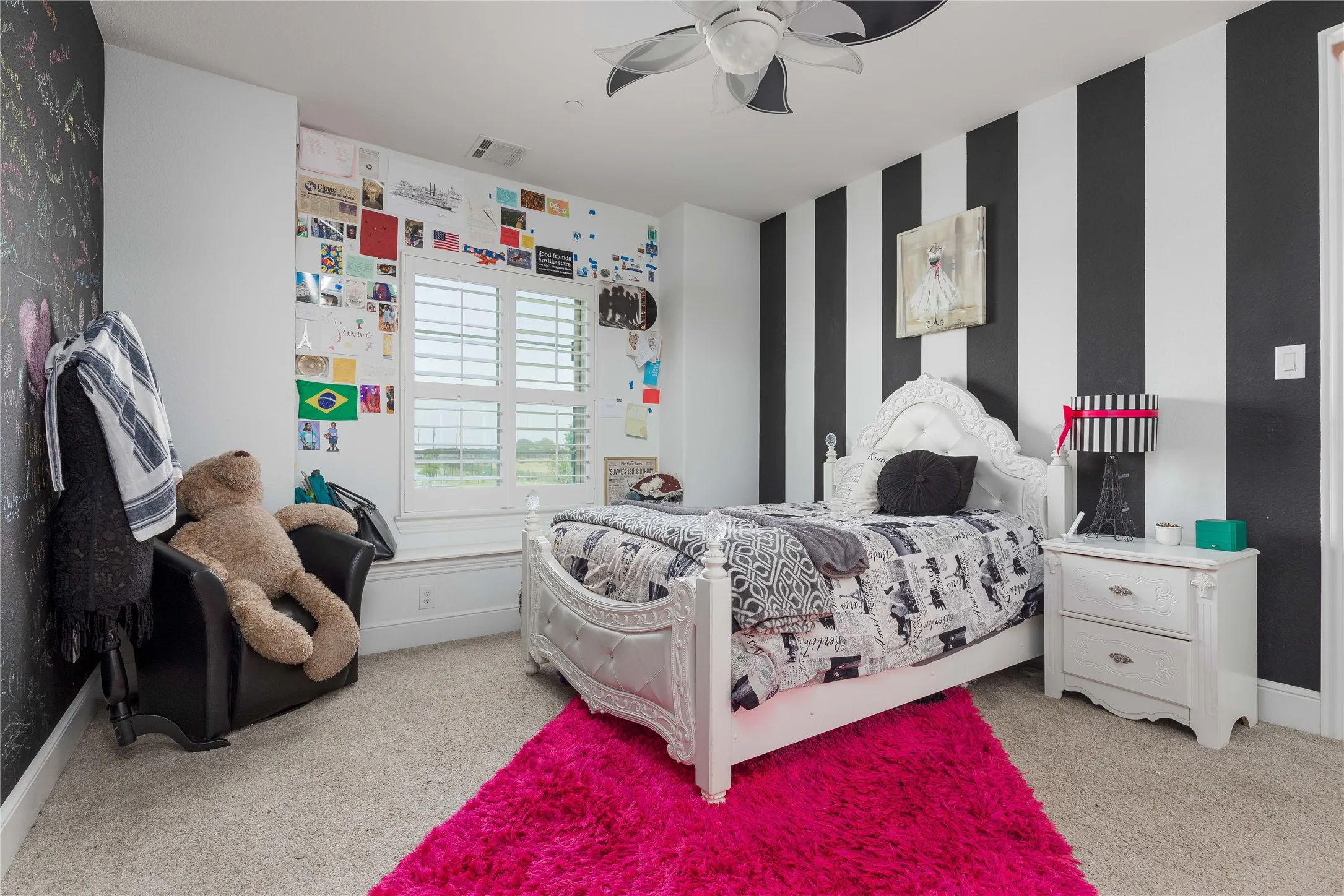Bedroom with a ceiling fan, wallpapered walls, light colored carpet, baseboards, and visible vents