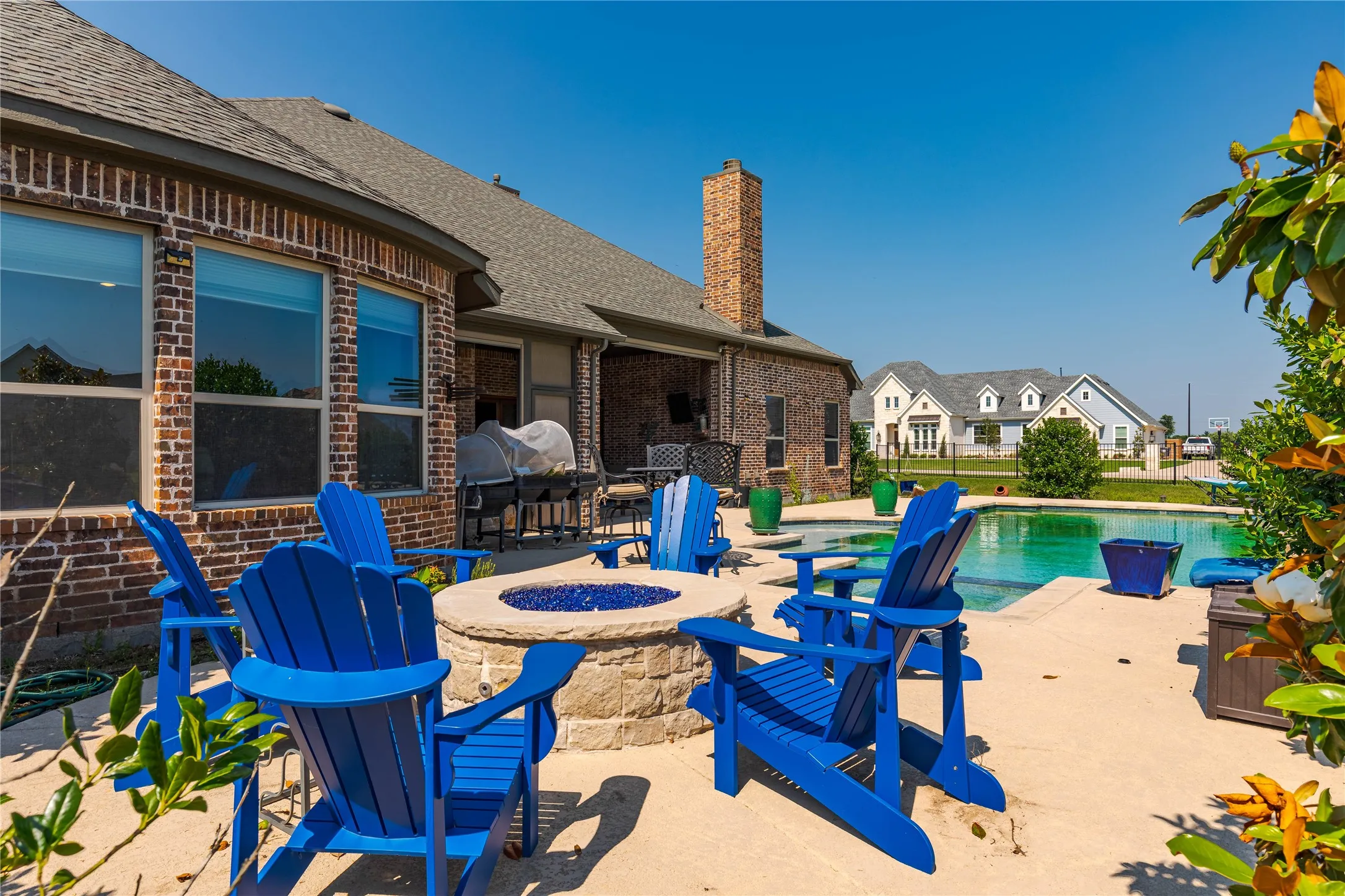 View of pool with a fenced in pool, a patio, and an outdoor fire pit