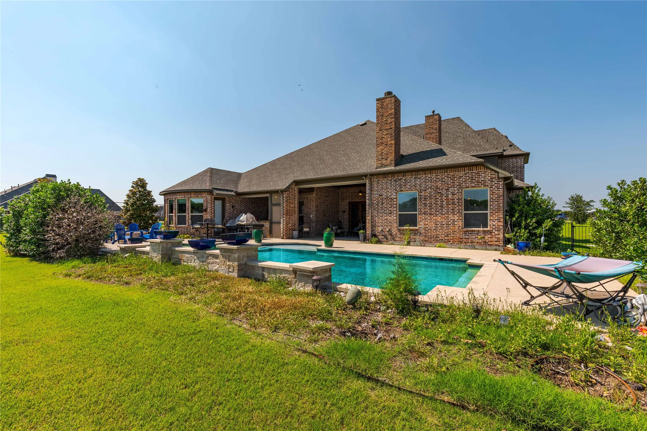 Pool featuring a yard and a patio
