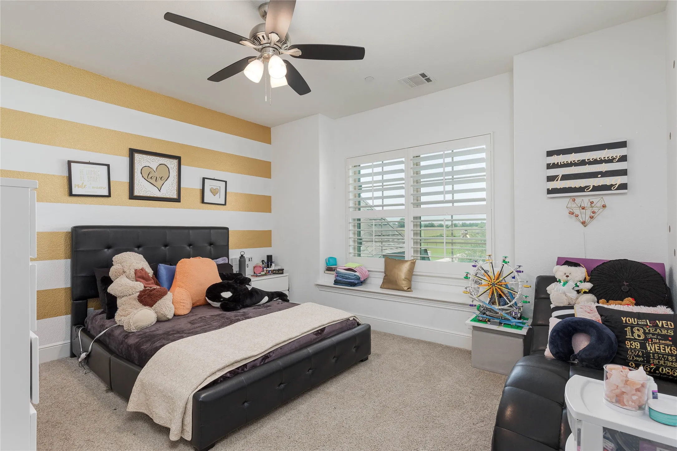 Bedroom with visible vents, carpet floors, and ceiling fan