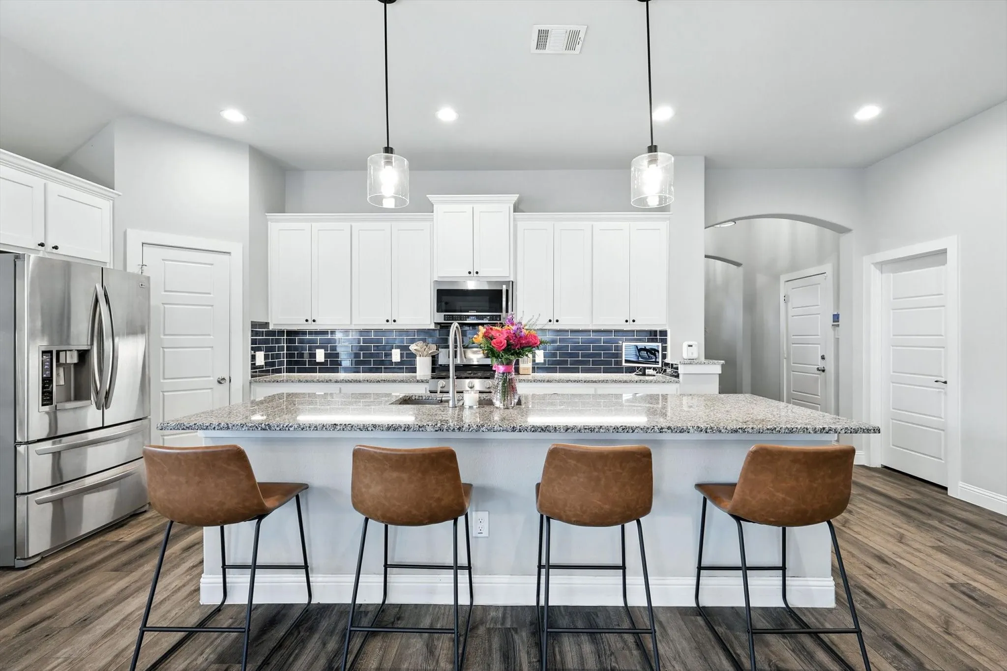 Large kitchen island with granite countertops.