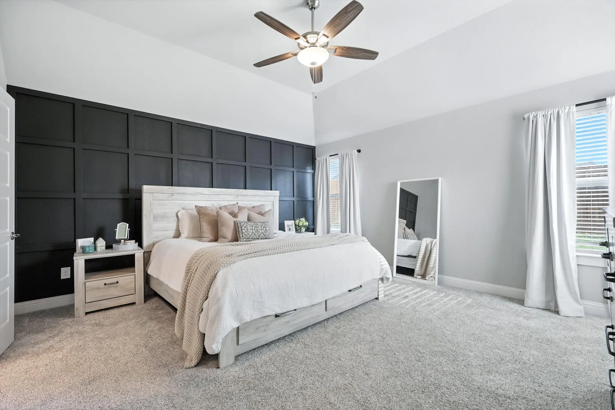 Large primary bedroom with gorgeous accent wall.
