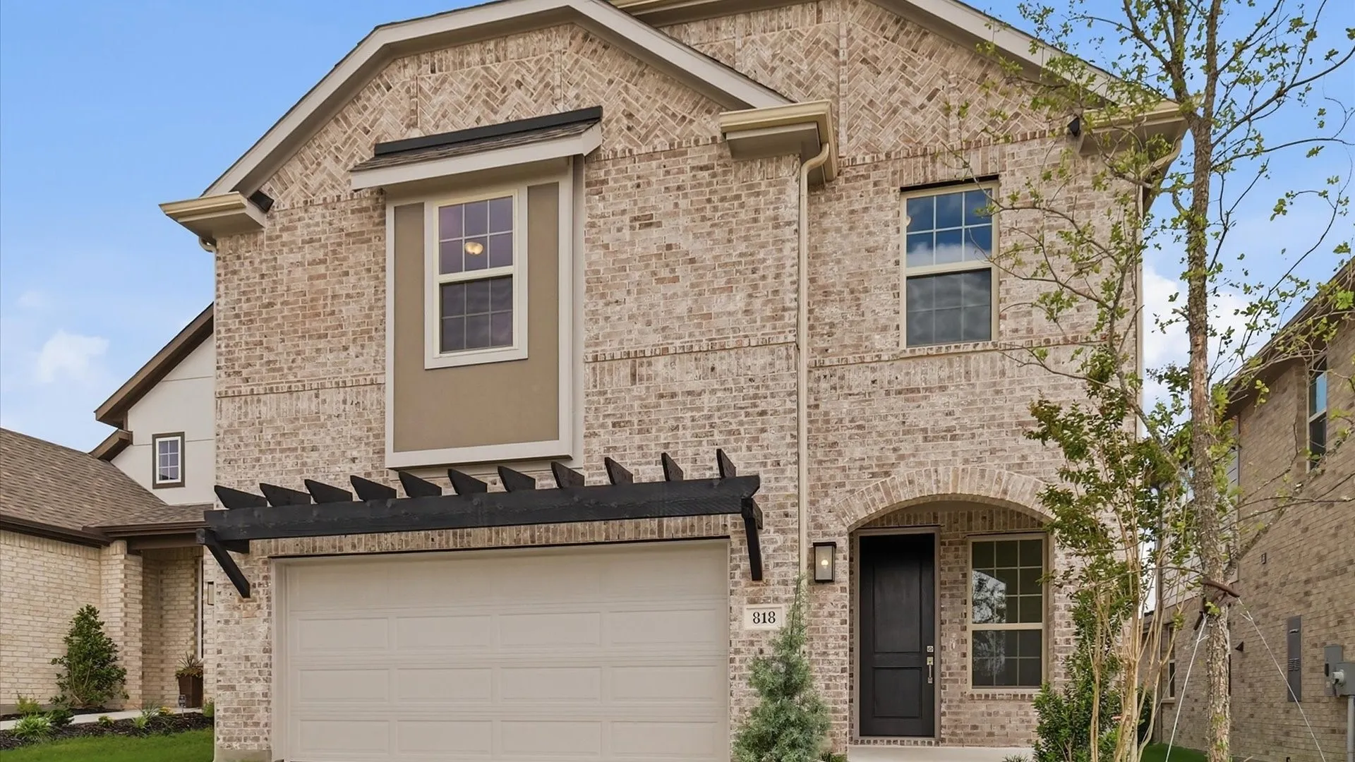Two-story brick exterior with an arched entryway