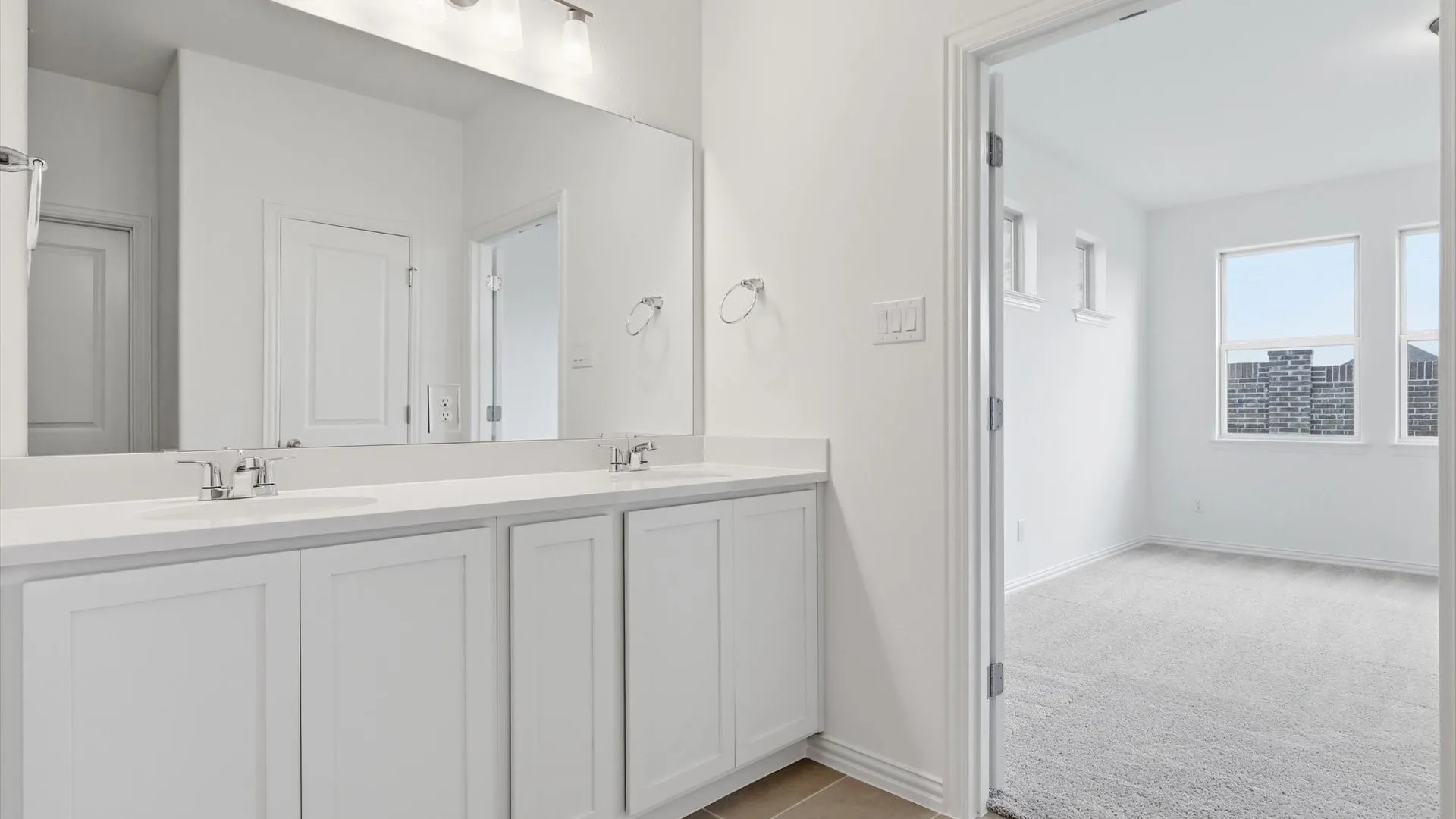 Double vanity with white cabinetry and integrated sinks