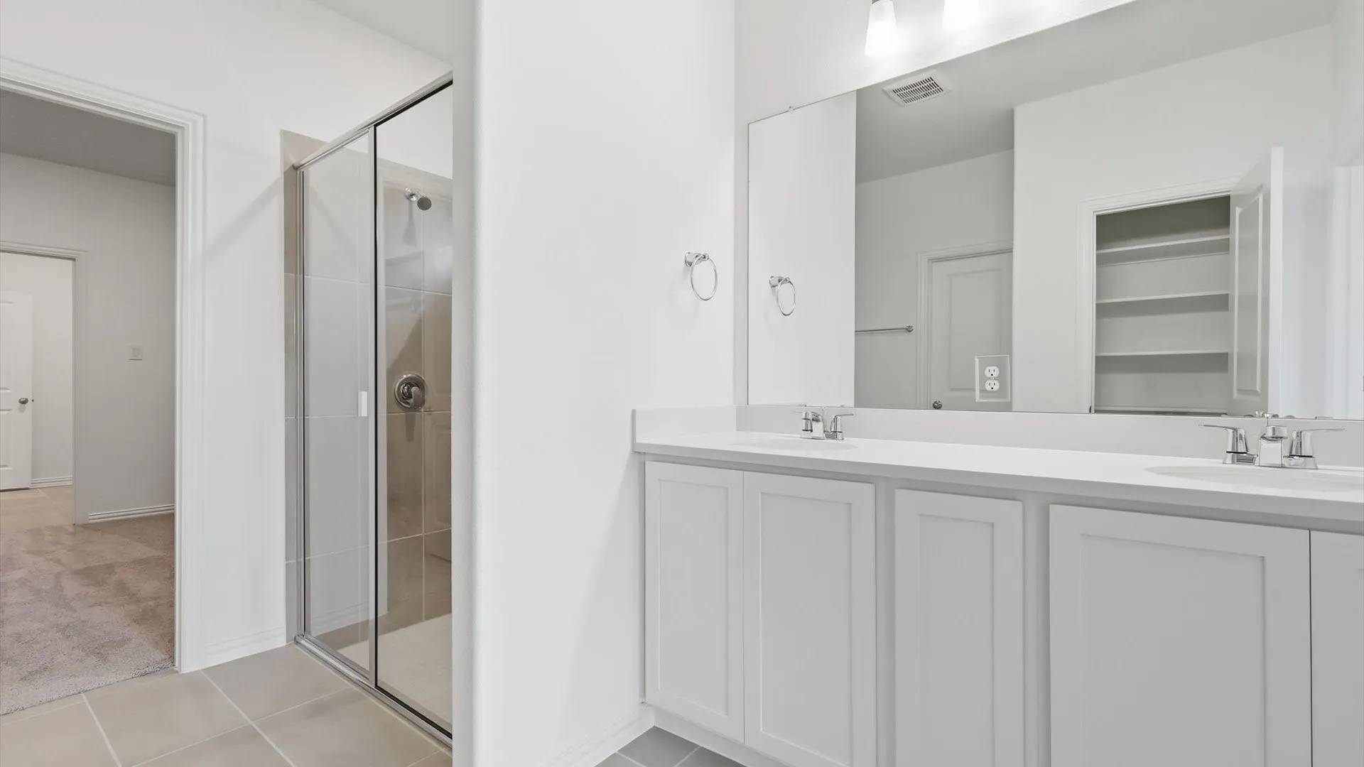 Double vanity with white cabinetry and integrated sinks