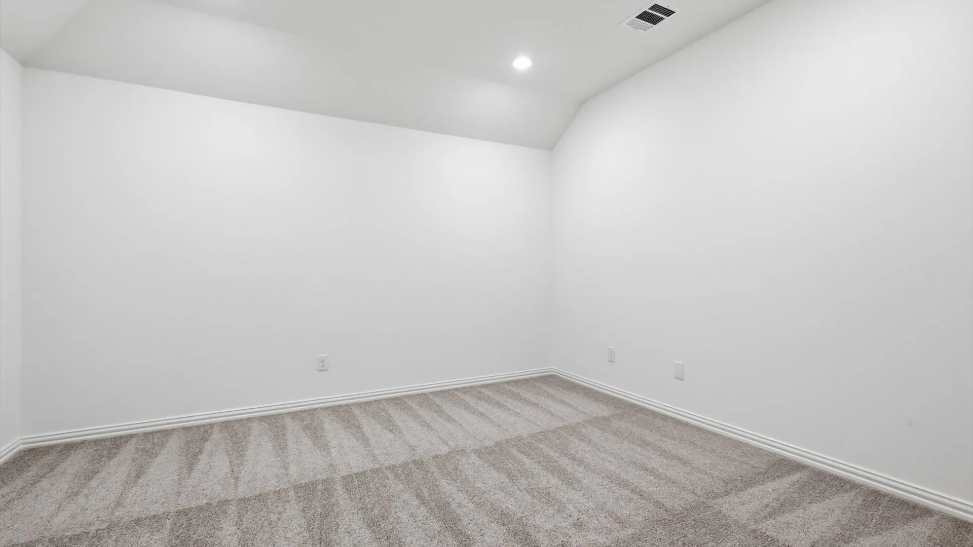 Neutral wall finishes and patterned carpet flooring