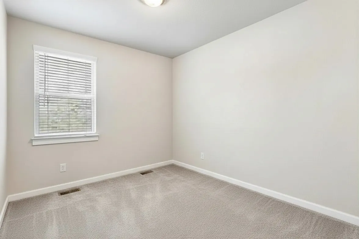 Neutral-toned walls and plush carpeting create a versatile interior