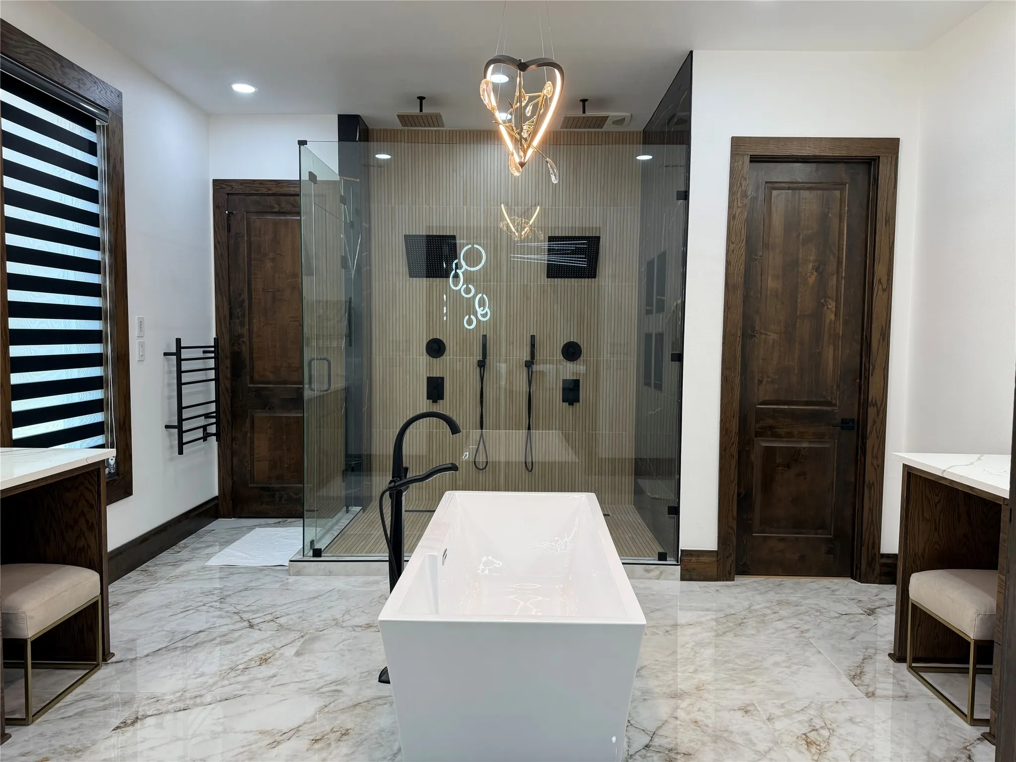 Full bathroom featuring vanity, a soaking tub, a stall shower, recessed lighting, and light marble finish floors