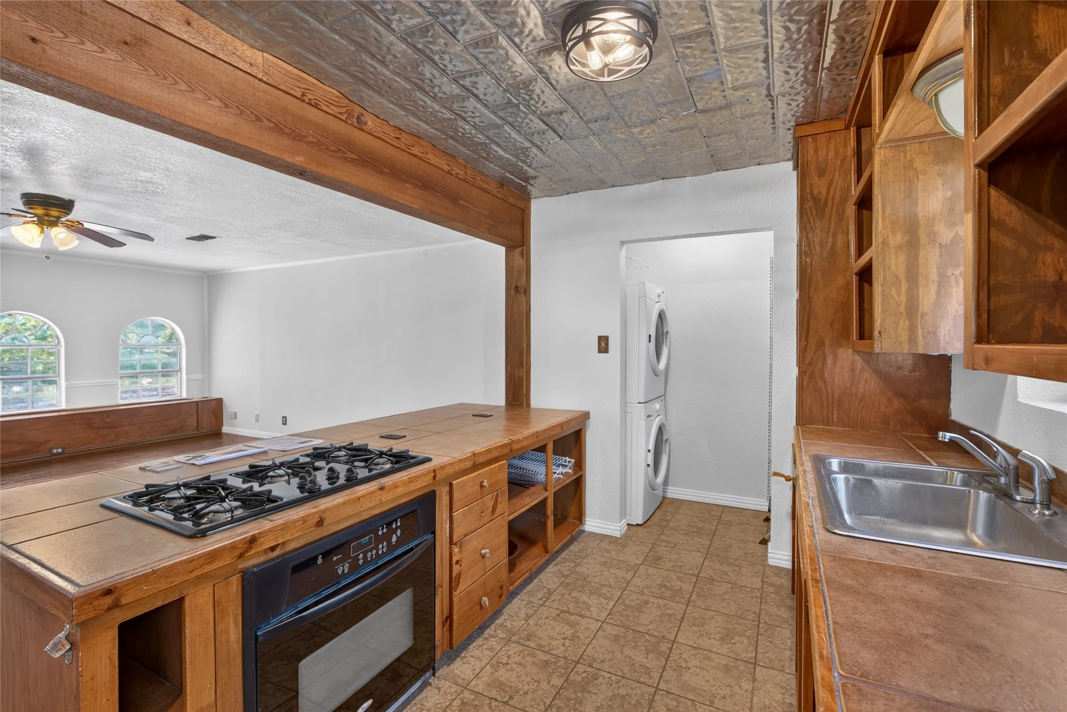 Kitchen featuring a built-in gas cooktop, integrated oven, and wood-finish cabinetry