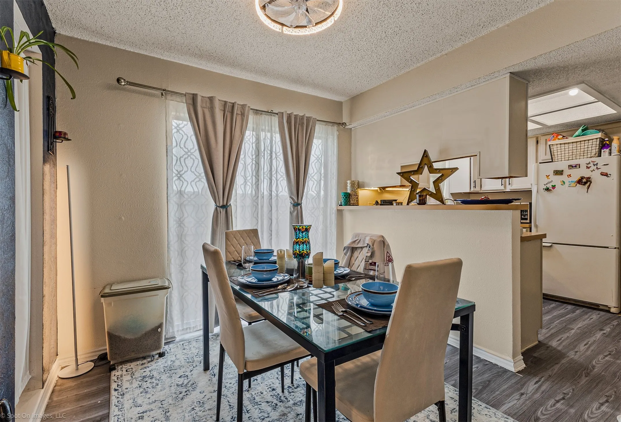Unit A dining area toward kitchen showing side door to backyard and patio