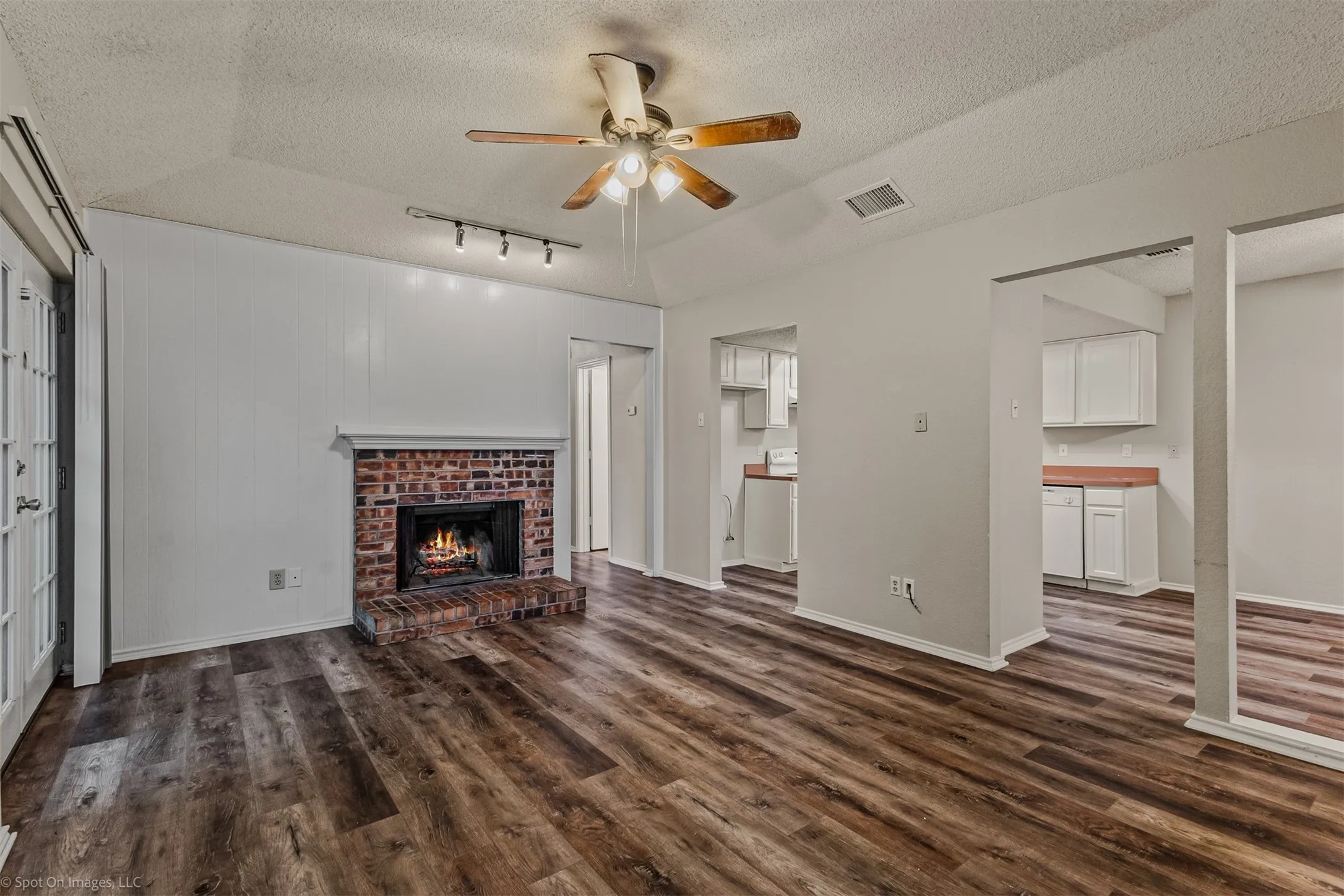 View of the kitchen from the living room also featuring LVP flooring
