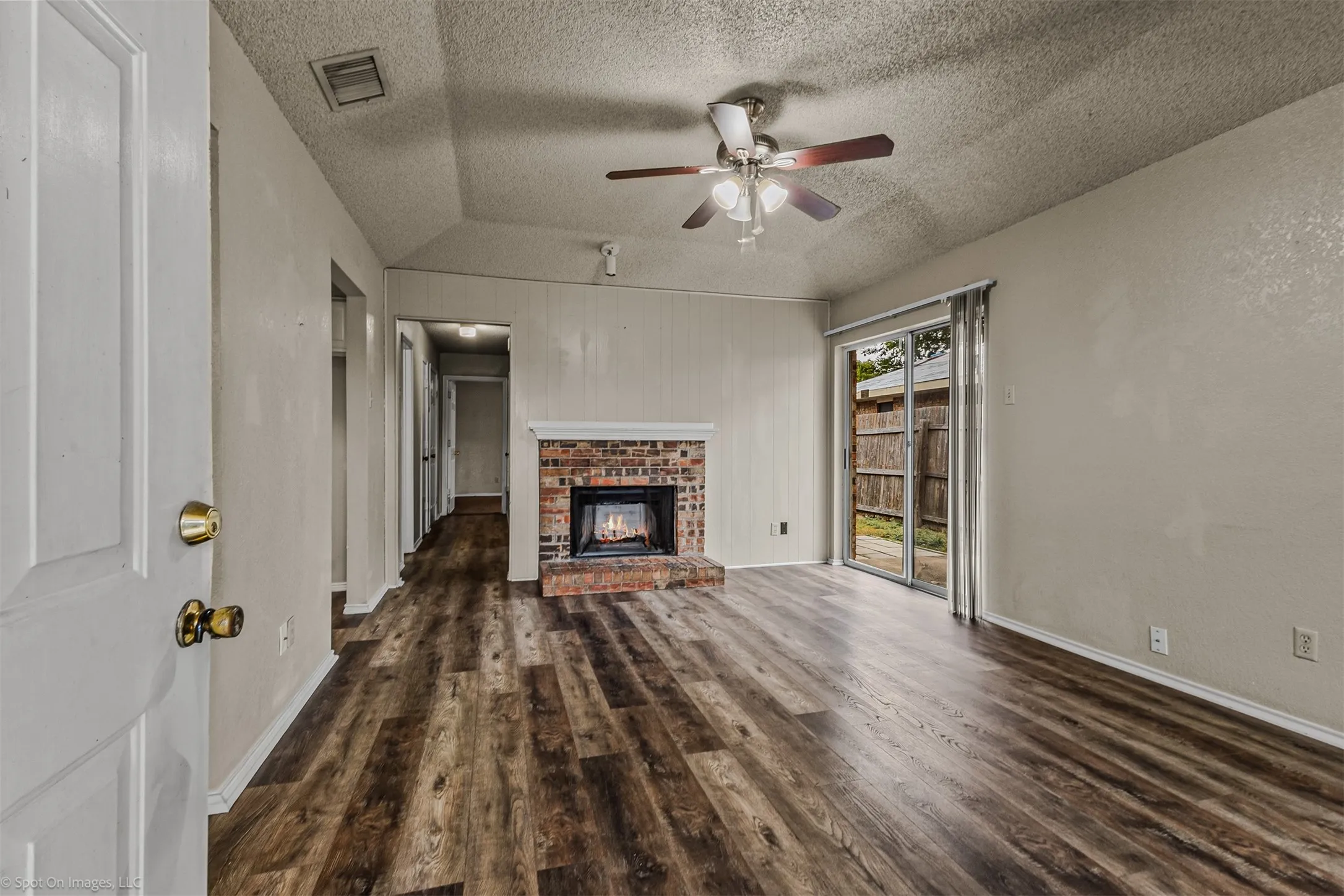 Unit B Featuring a wood burning fireplace and a door to the exterior patio and easy to care  for LVP flooring