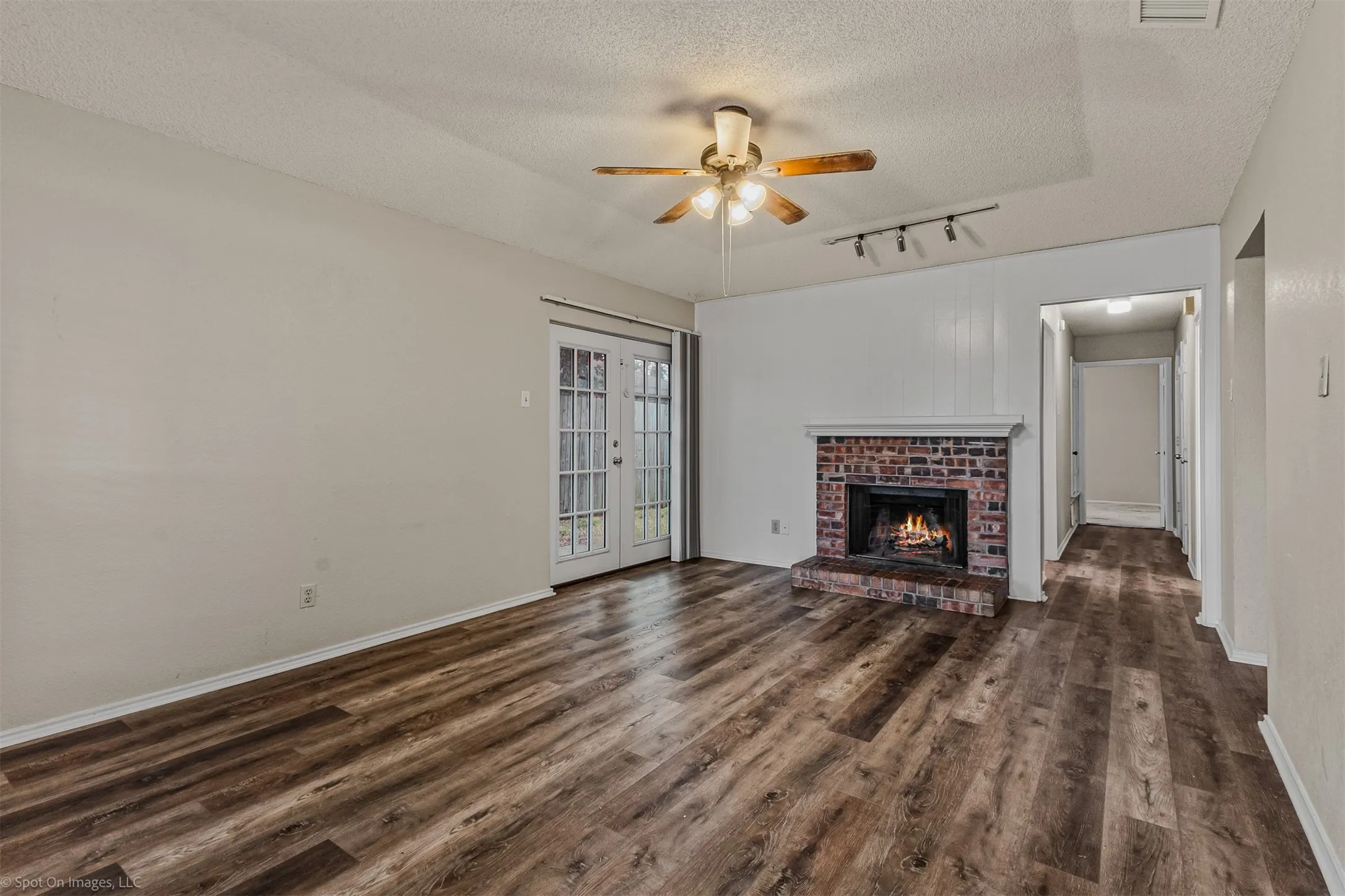 Featuring a wood burning fireplace and a door to the exterior patio and easy to care  for LVP flooring