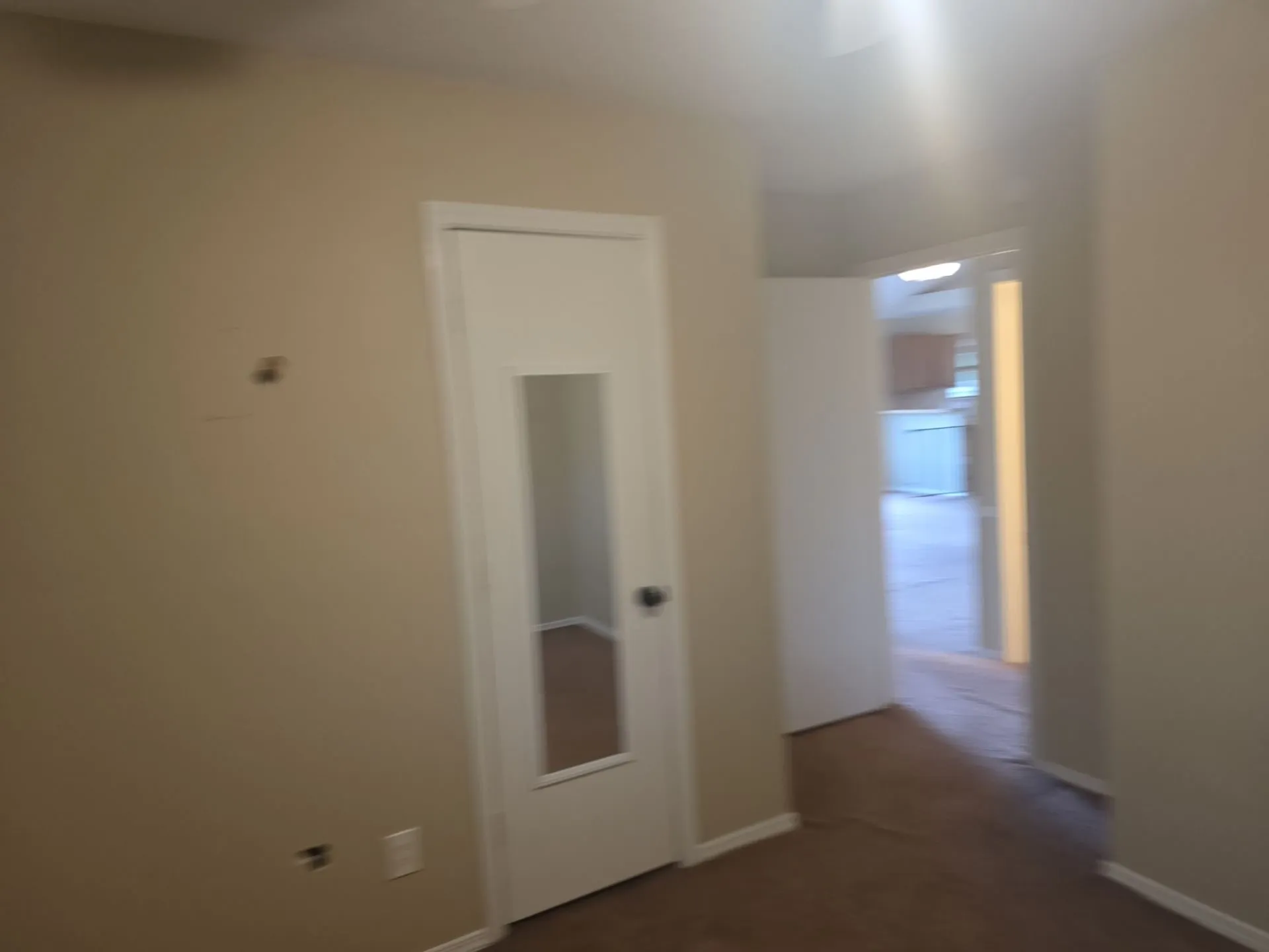 Interior space with neutral-toned walls and carpeted flooring