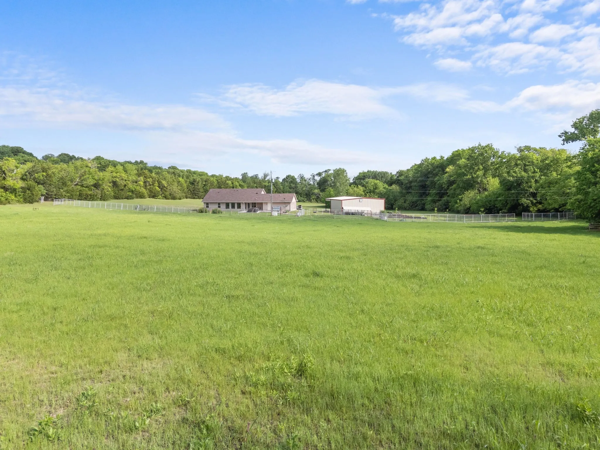 Back view of home from fenced in pasture