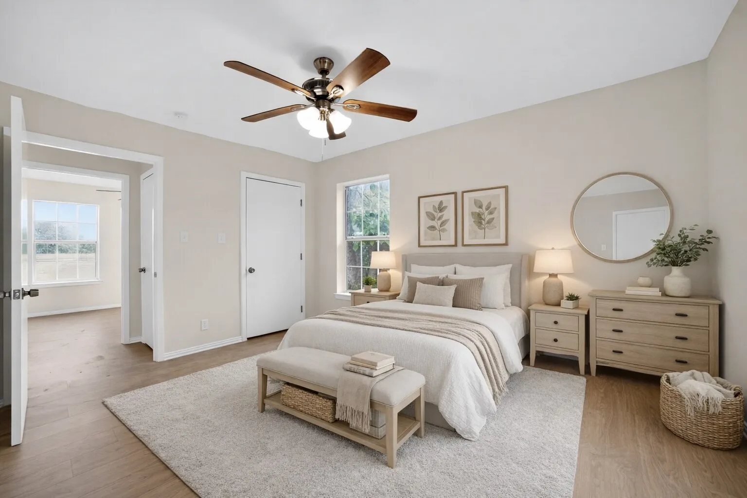 The property features light-colored walls, hardwood flooring, and a ceiling fan with light fixture - Virtually Staged