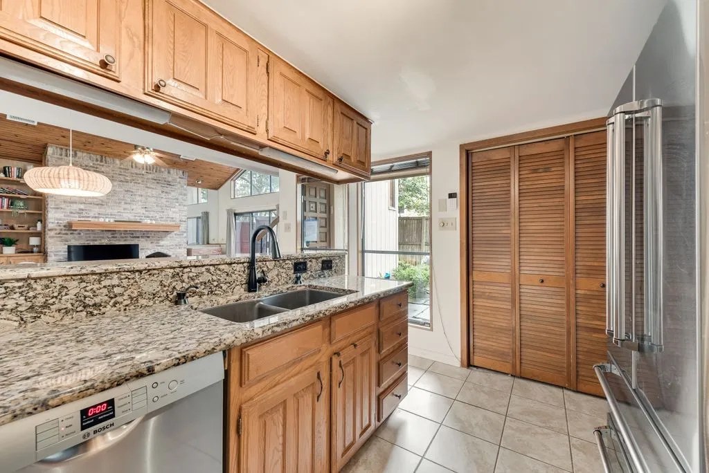 Warm wood cabinetry and generous counter space create a kitchen that feels both practical and inviting.