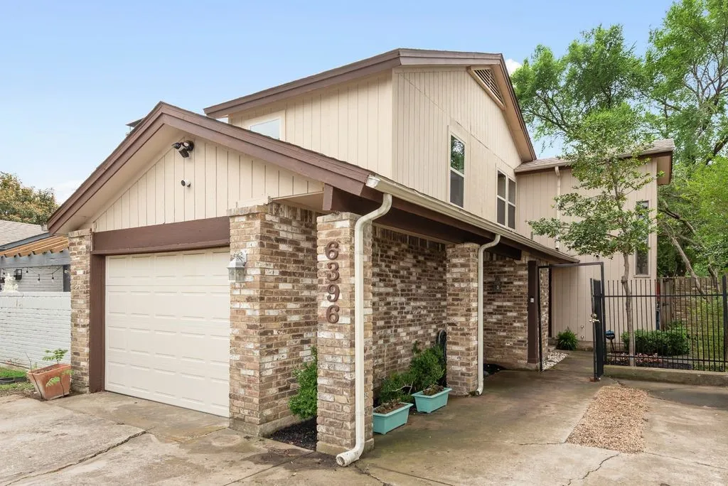A distinctive blend of brick and siding, this architecturally unique home is tucked behind a private gated entry on a quiet East Dallas cul-de-sac.