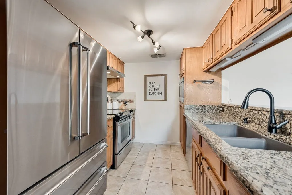 Granite countertops and stainless steel appliances bring both function and durability to the kitchen.