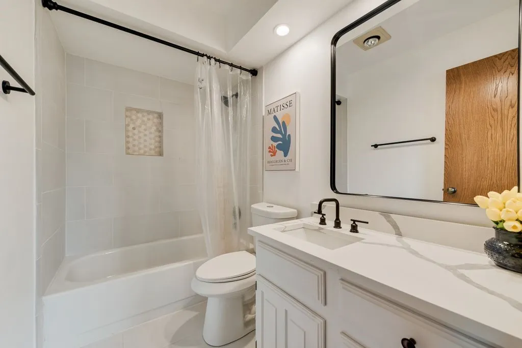 The secondary bath features clean finishes and a simple, functional layout.
