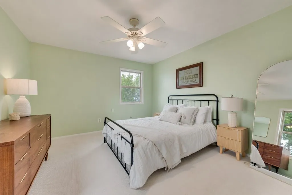 A bright secondary bedroom with soft natural light creates a comfortable and inviting retreat.