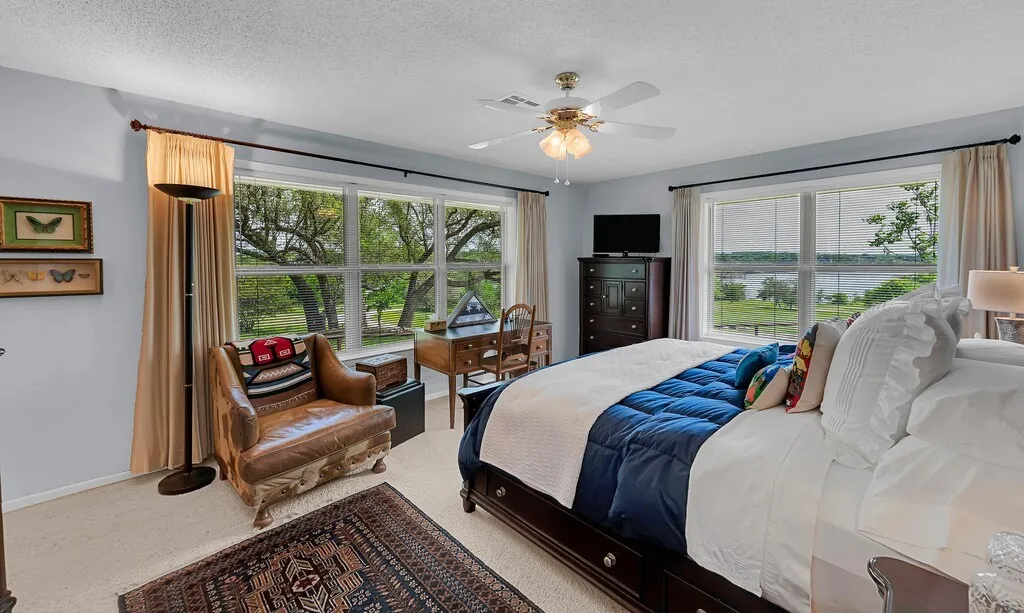 Second primary suite featuring lake through from windows in 2 directions.
