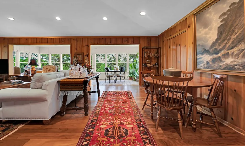 Entry into this elegant Space vaulted ceiling interior featuring wood paneling, recessed lighting, hand scraped hard scraped tigerwood flooring, & positioned nicely between sunroom and impressive kitchen
