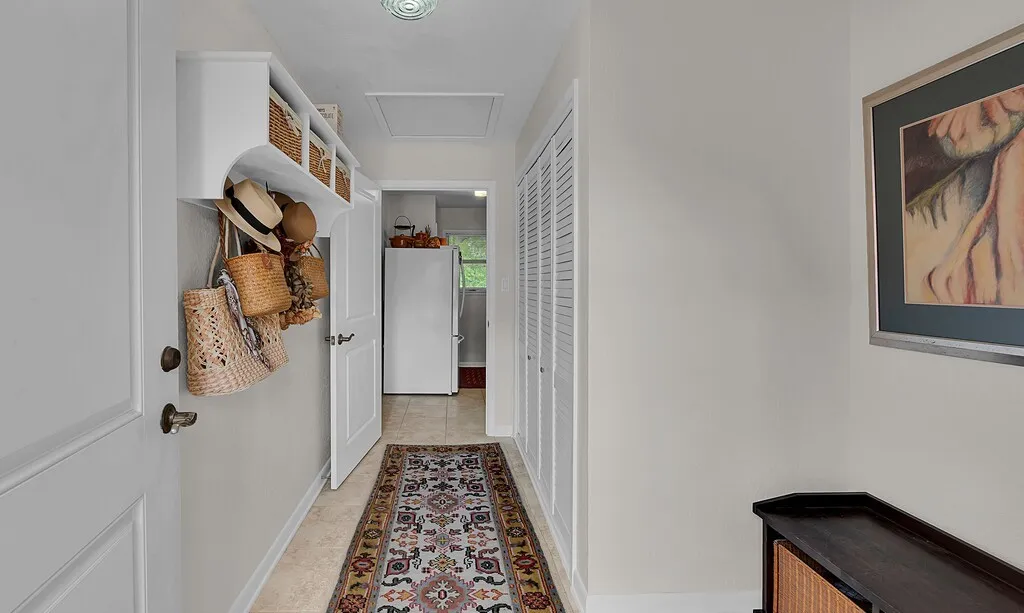 Easy convenient entry from garage & courtyard in separate wing, leads to primary suite