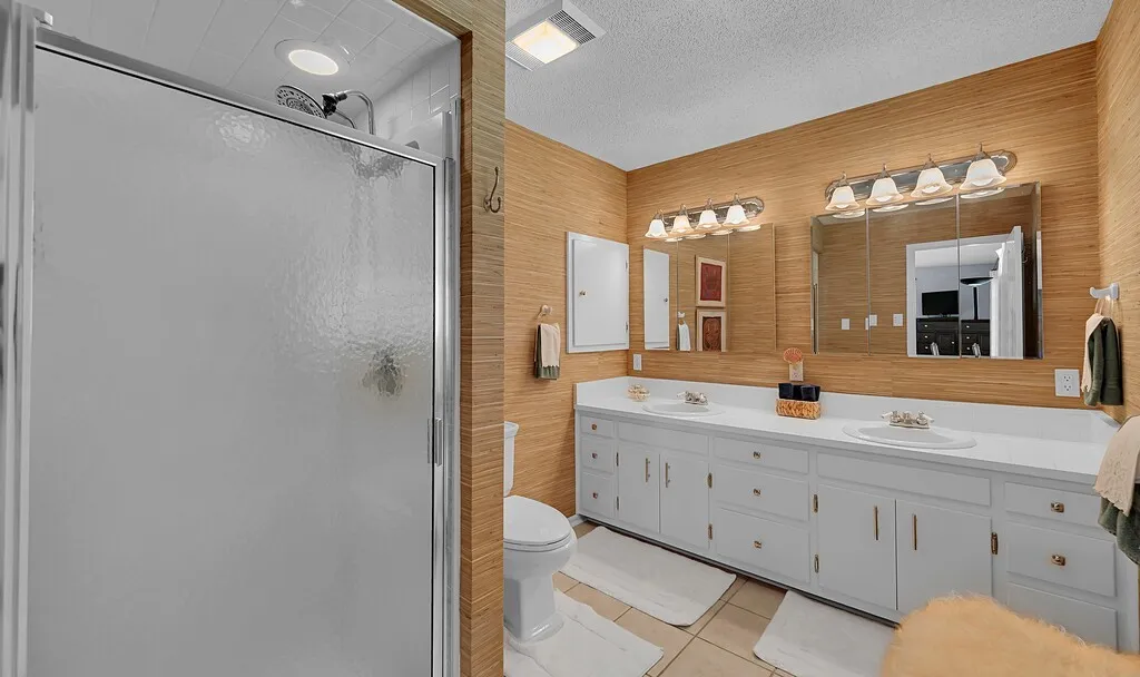 2nd primary bathroom in suite features a double vanity with ample storage