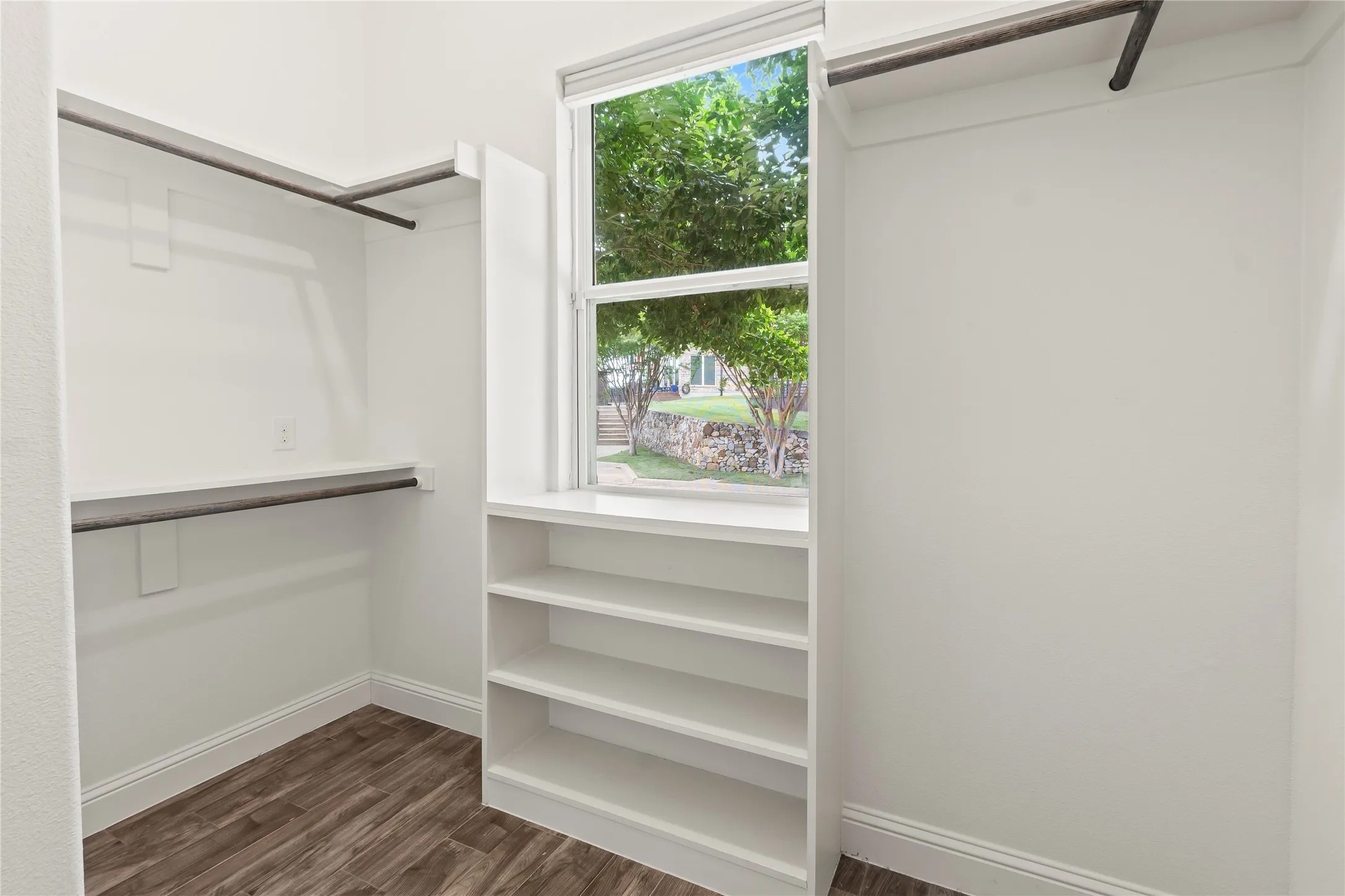 Primary bedroom apacious walk in closet with builtins