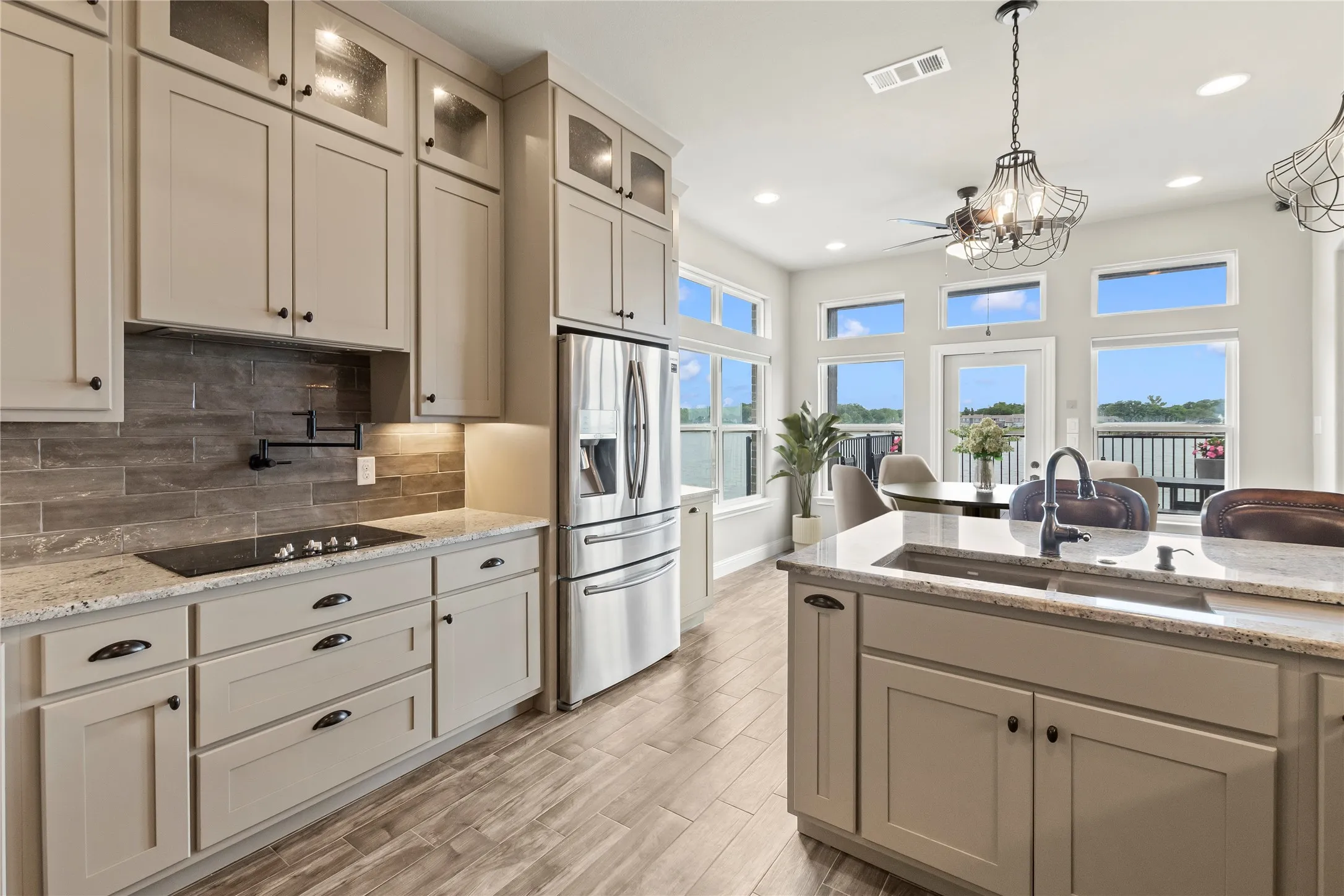 Staged Photo* Cooktop and beautiful granite counter tops, tile back splash and good cabinet storage.