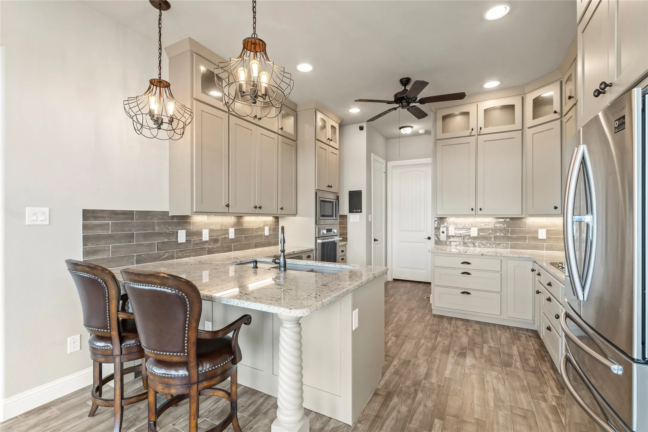 Illuminated custom cabinetry with soft close drawers, Rev-A-Shelf pullouts, Blanco sink with pot filler and Fisher and Paykel dish drawer.