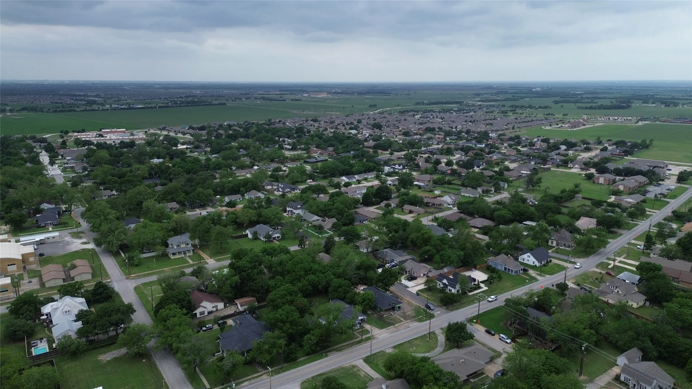 Aerial view of the neighborhood showcasing residential properties and mature trees