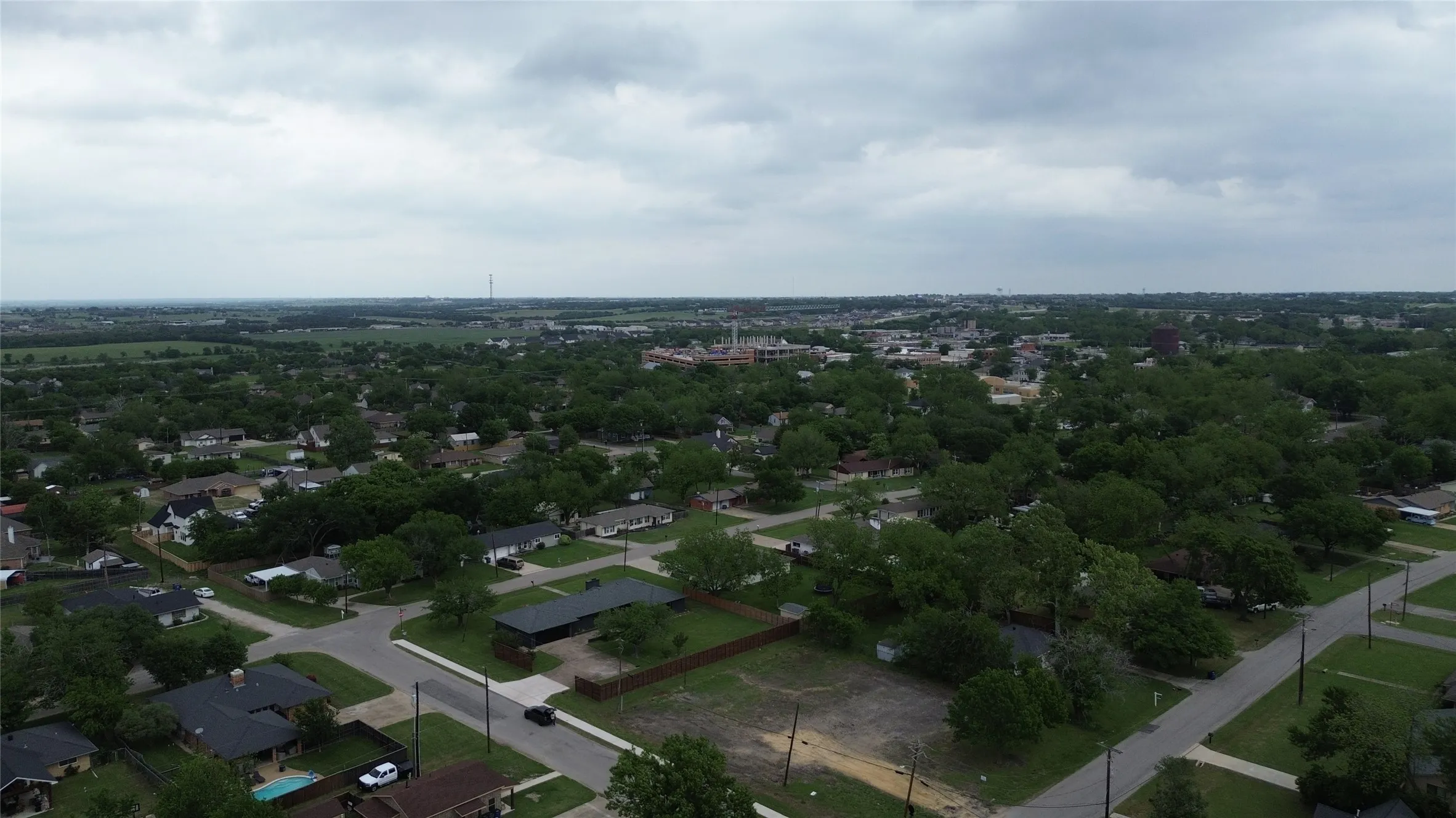 Expansive views of the surrounding neighborhood, featuring numerous residential properties, abundant green spaces, and a clear street layout