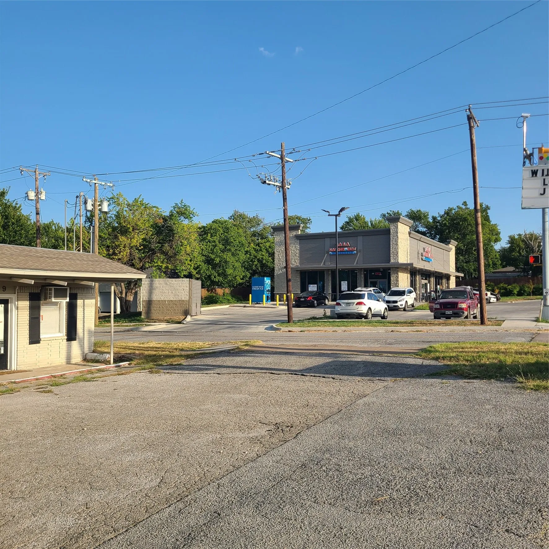 side picture of building for sale and new construction across the street.