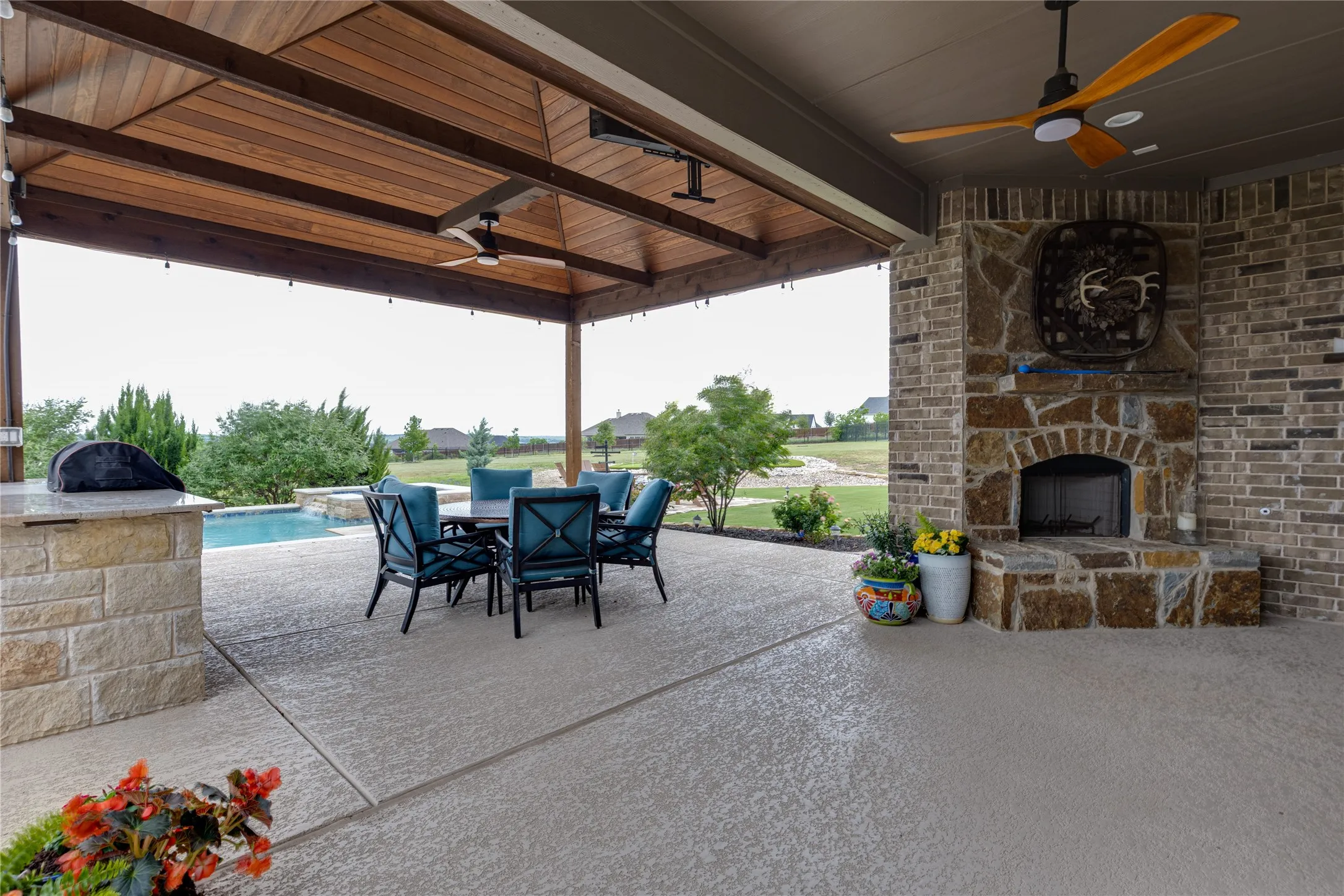 Extended patio with fireplace and outdoor kitchen