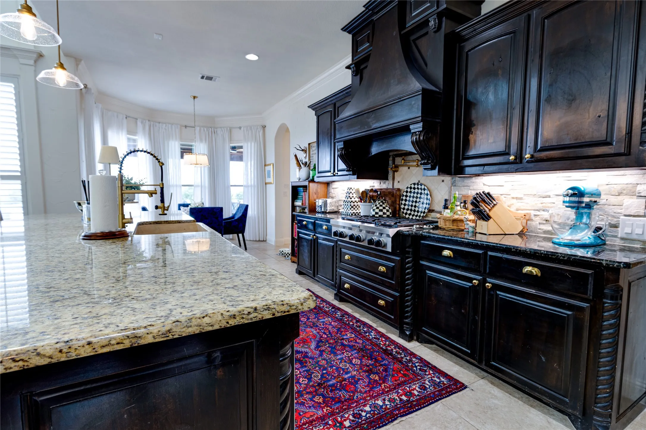 Kitchen with 6 burner gas cooktop, double ovens, built in microwave, pot filler
