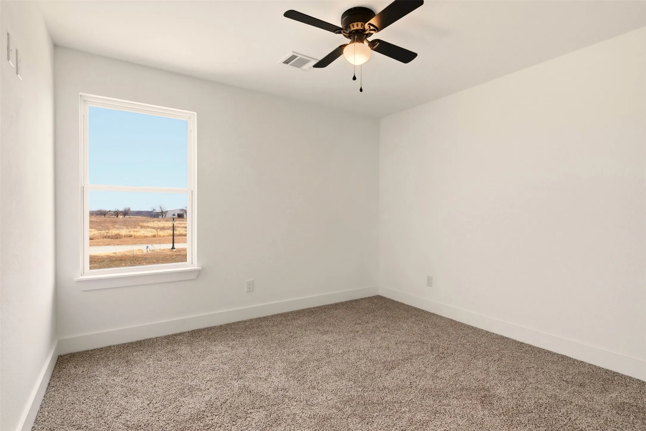 This room features light-colored walls and carpeted flooring