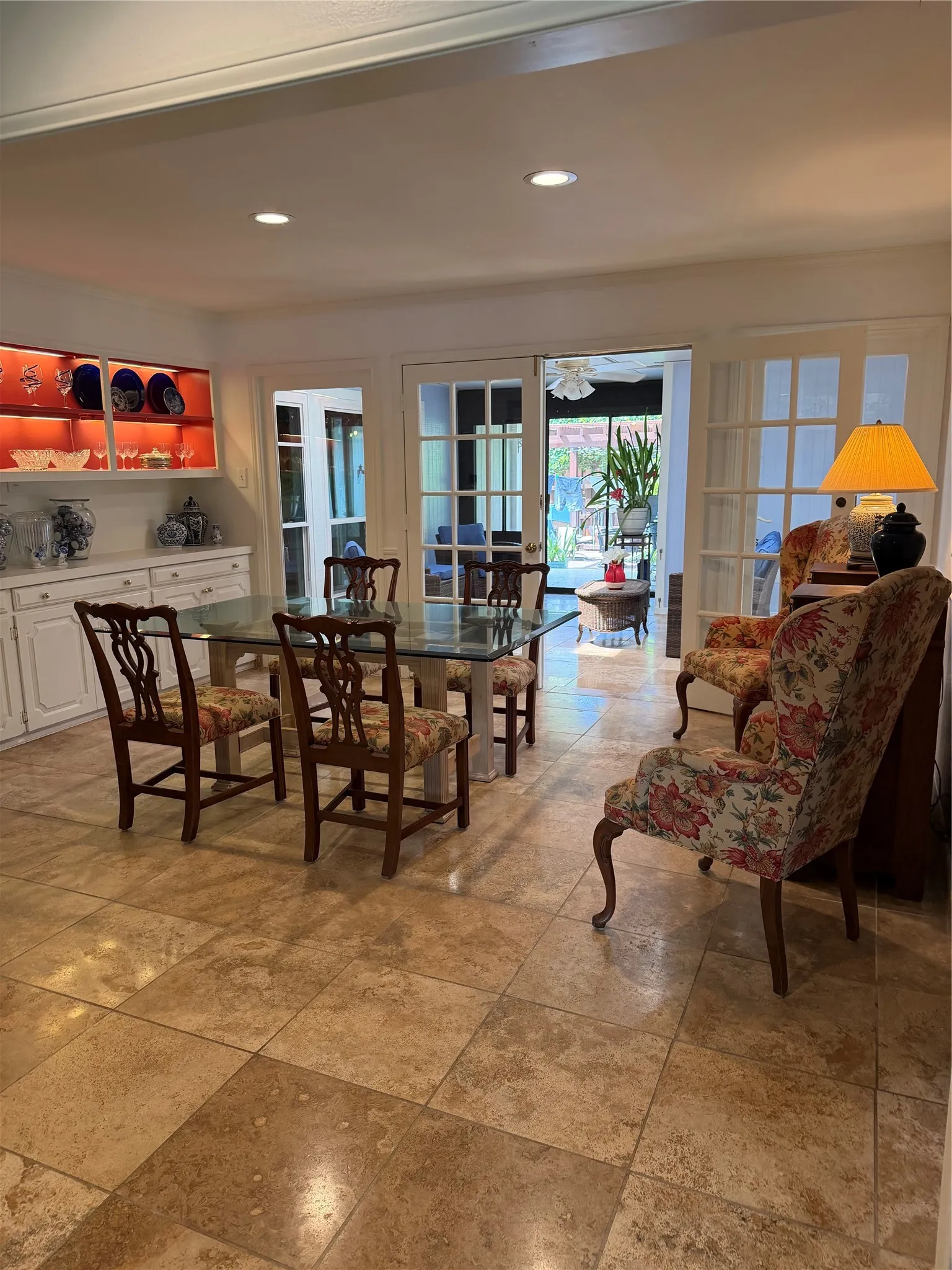 Refreshed painting on all walls. Recessed ceiling lighting, tiled flooring, French doors, and built-in cabinetry with illuminated display shelves