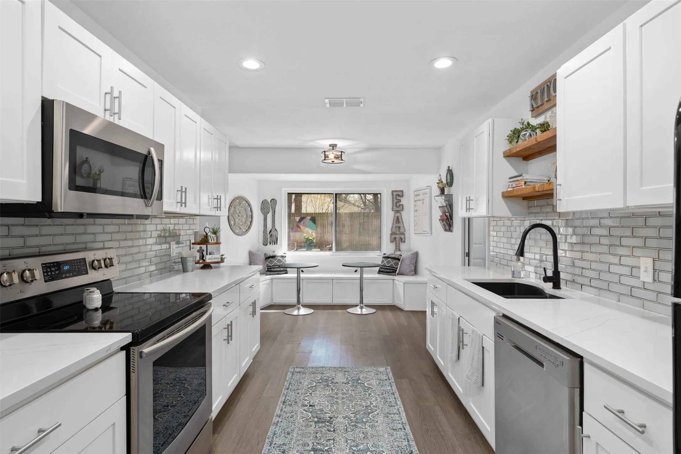 This gorgeous kitchen leads right to the breakfast area with built-in banquet seeting!