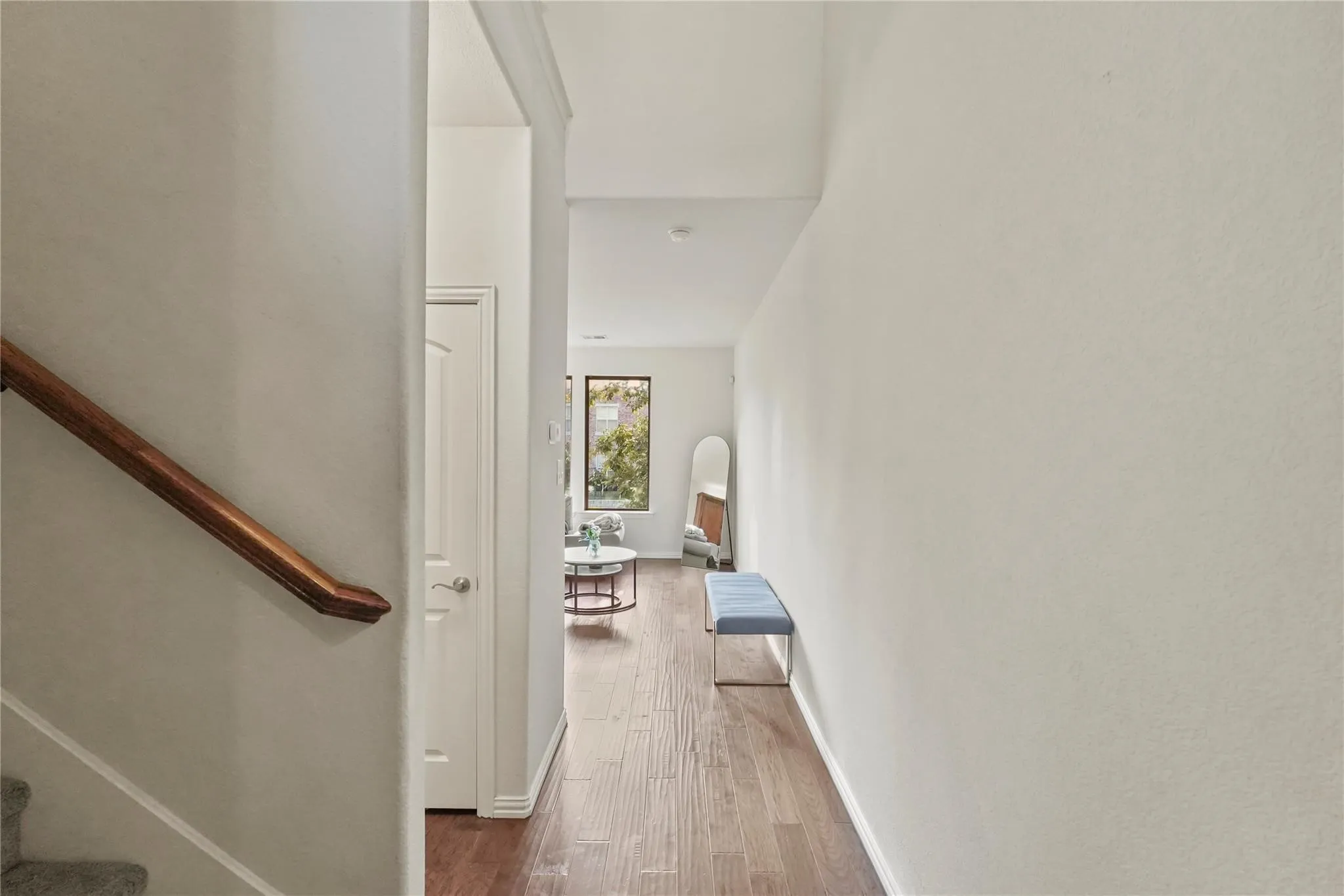 Hallway with stairs and dark wood-type flooring
