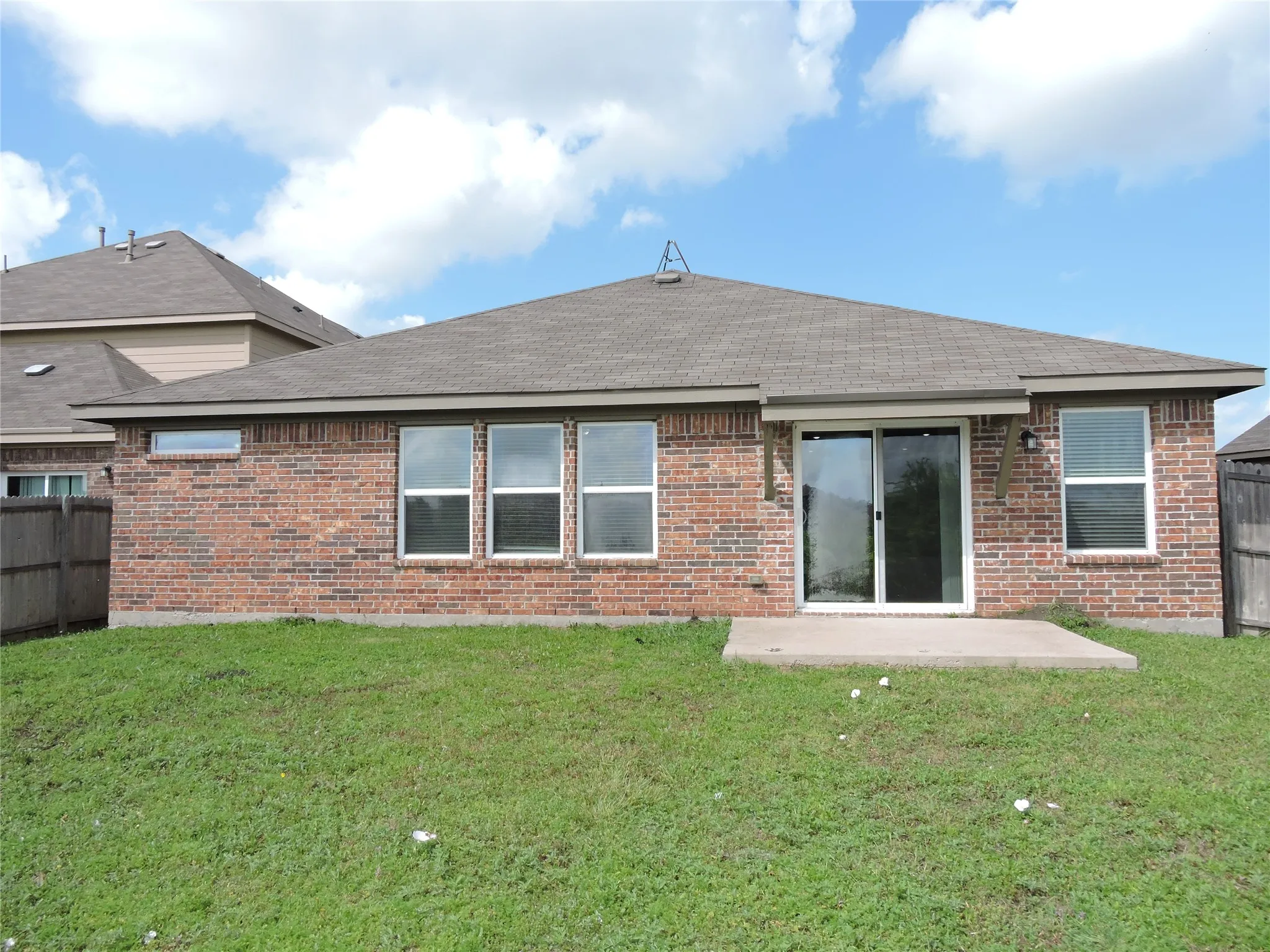 The property features a brick exterior with a shingled roof