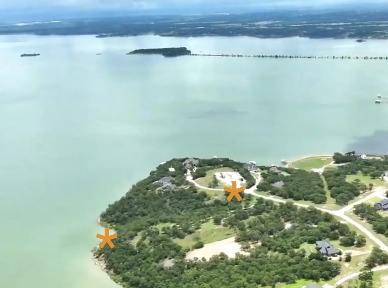Waterfront property featuring extensive tree coverage, shoreline access, and a developed road system