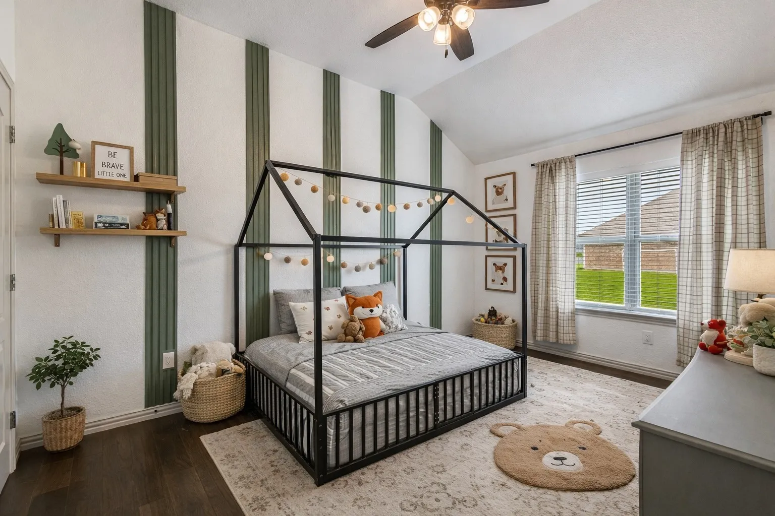 This room features a vaulted ceiling with a ceiling fan, dark hardwood floors, and a window providing natural light
